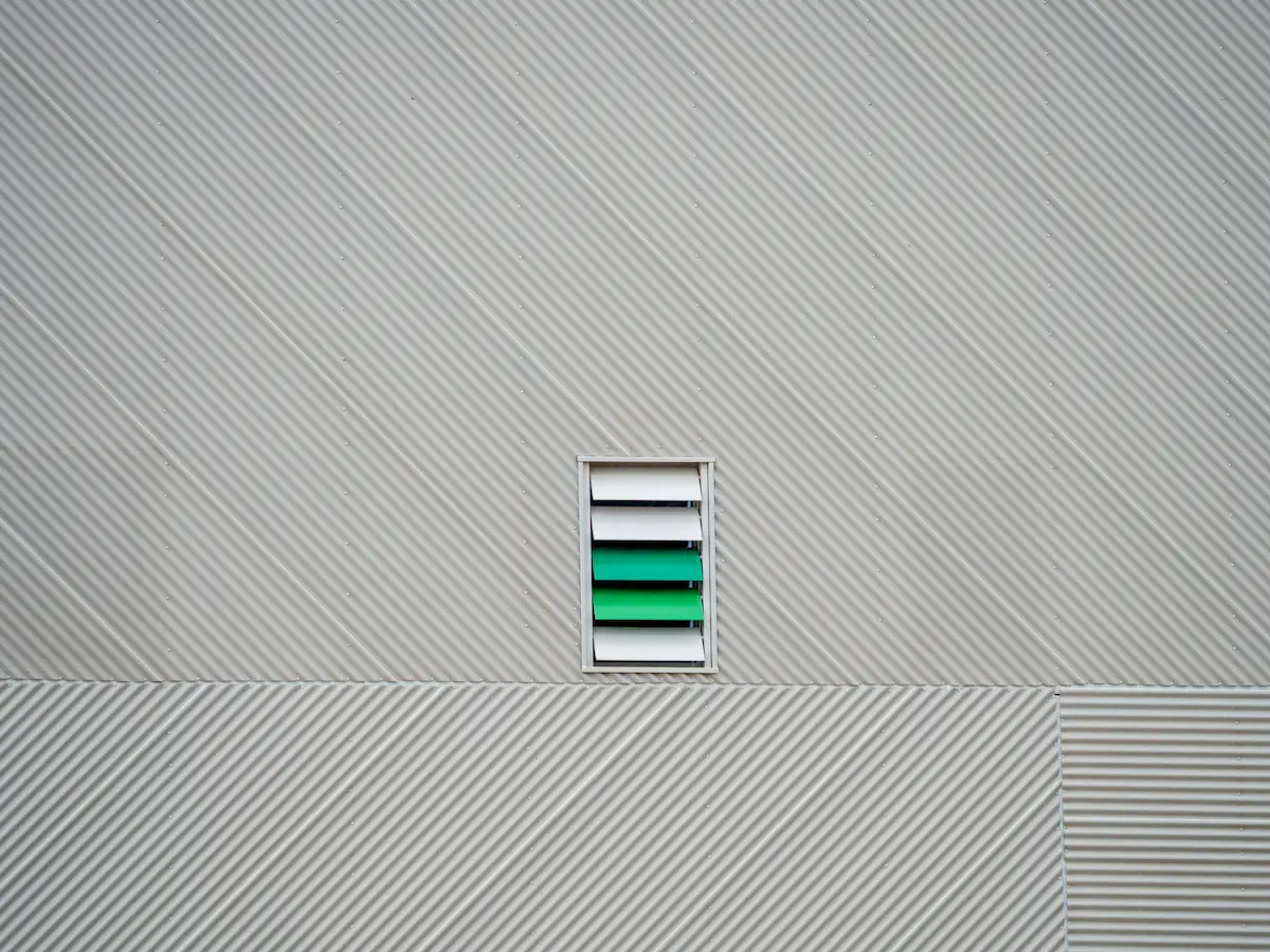 colorful wall vent in Zaragoza, Spain, featuring minimalist design with bold accent colors and a small window
