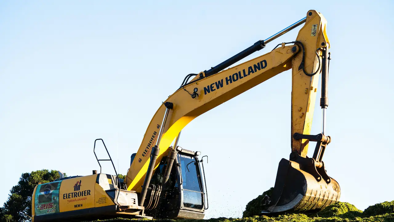 An excavator digging the foundation for a construction project.