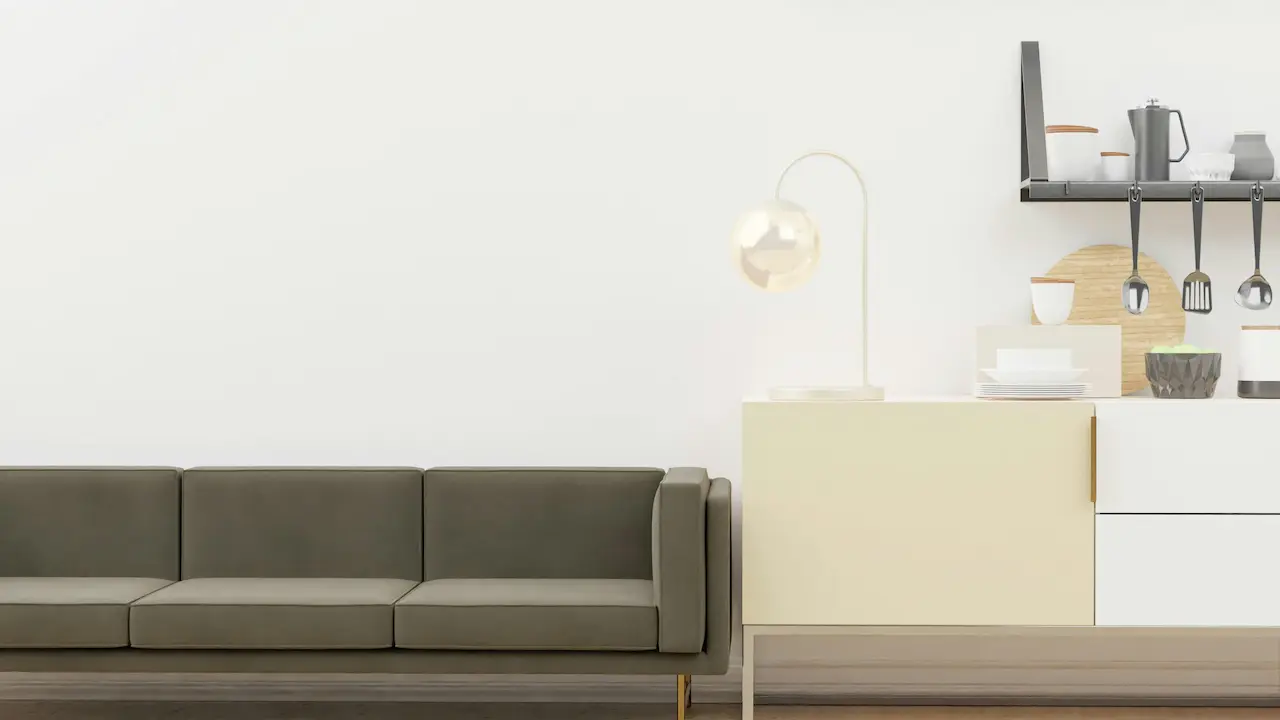 Gray and white couch placed next to a white wall in a minimalist living space.