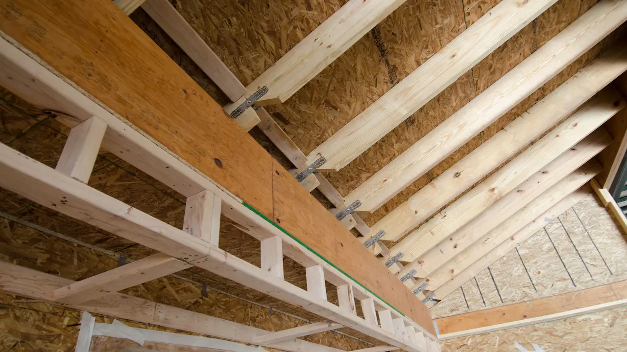 Hinged metal roof rafters on an energy-efficient manufactured home, designed for easy transport and installation.