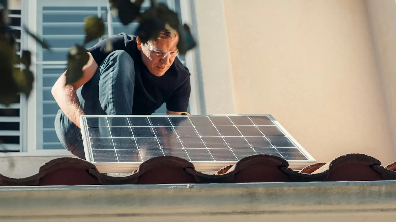 a homeowner installing a solar panel on the roof, promoting sustainability and renewable energy practices
