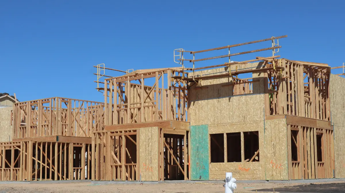 Framing of a house under construction, showcasing the structural skeleton of the building.