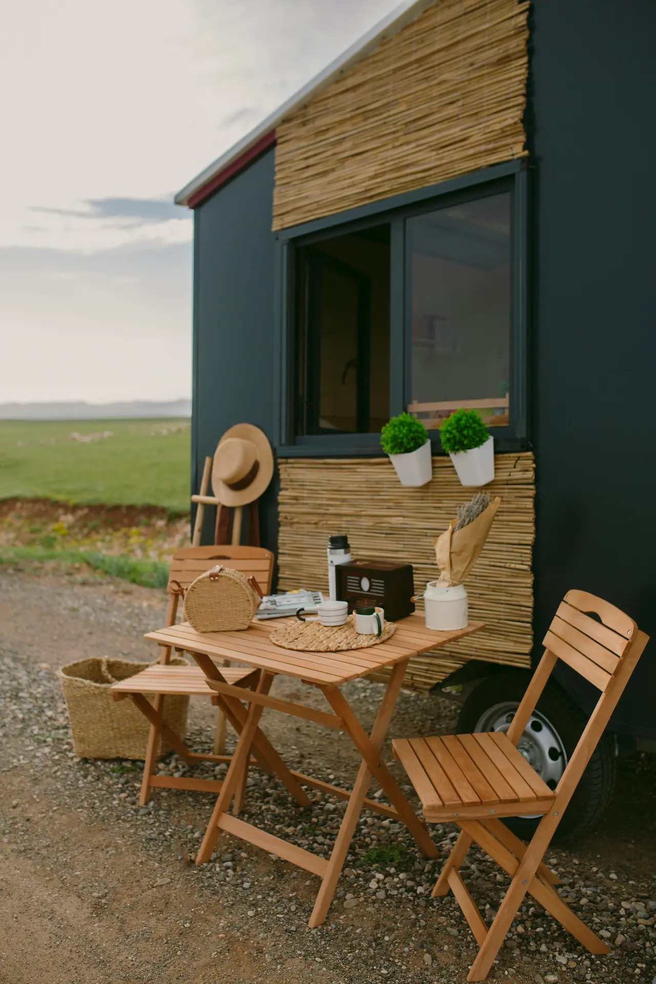 A table and chairs for two at a cozy little beach house, perfect for a relaxed dining experience.