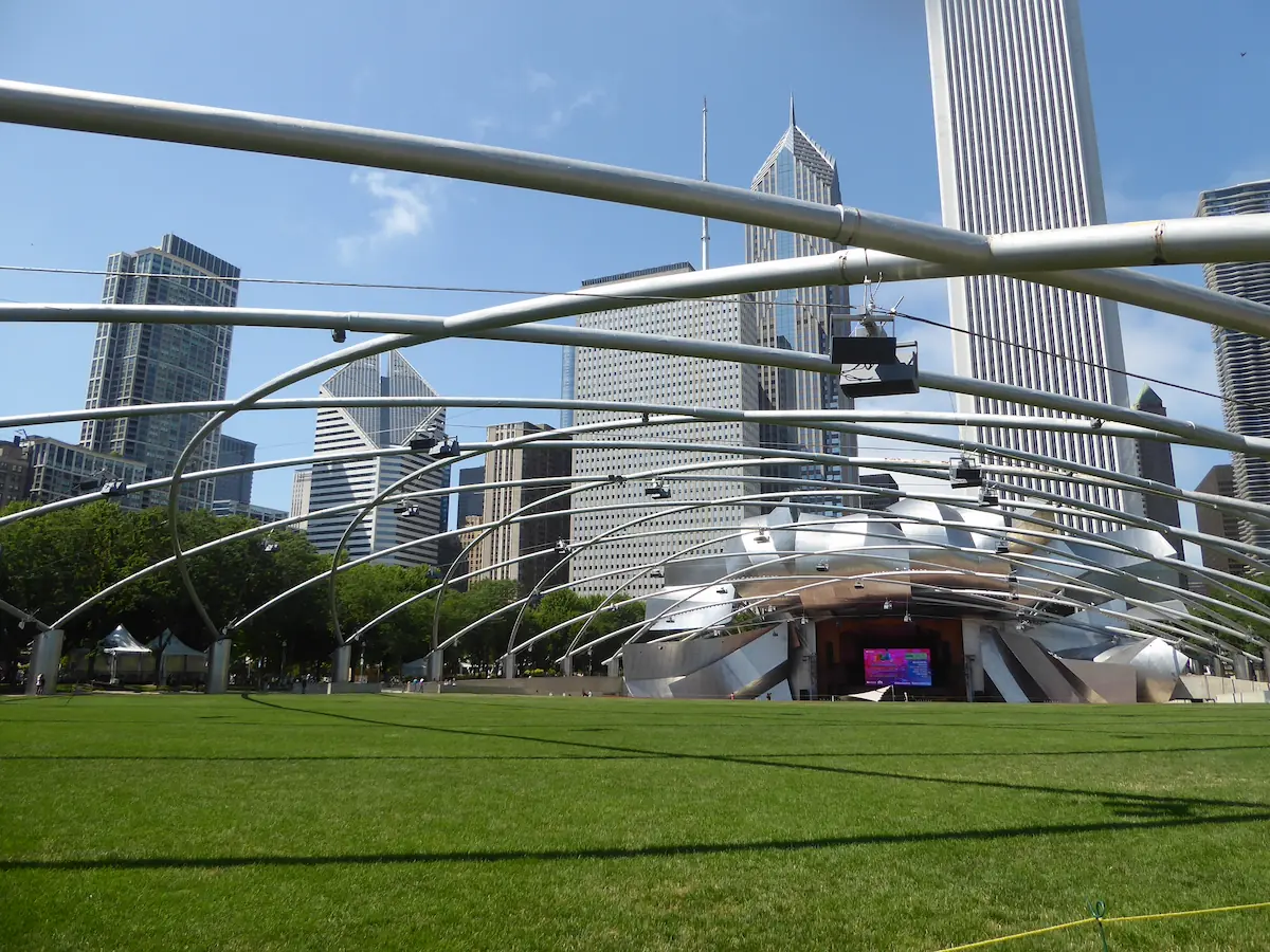 Curving steel panels of the Pritzker Pavilion in Chicago, showcasing an innovative design by Frank Gehry.