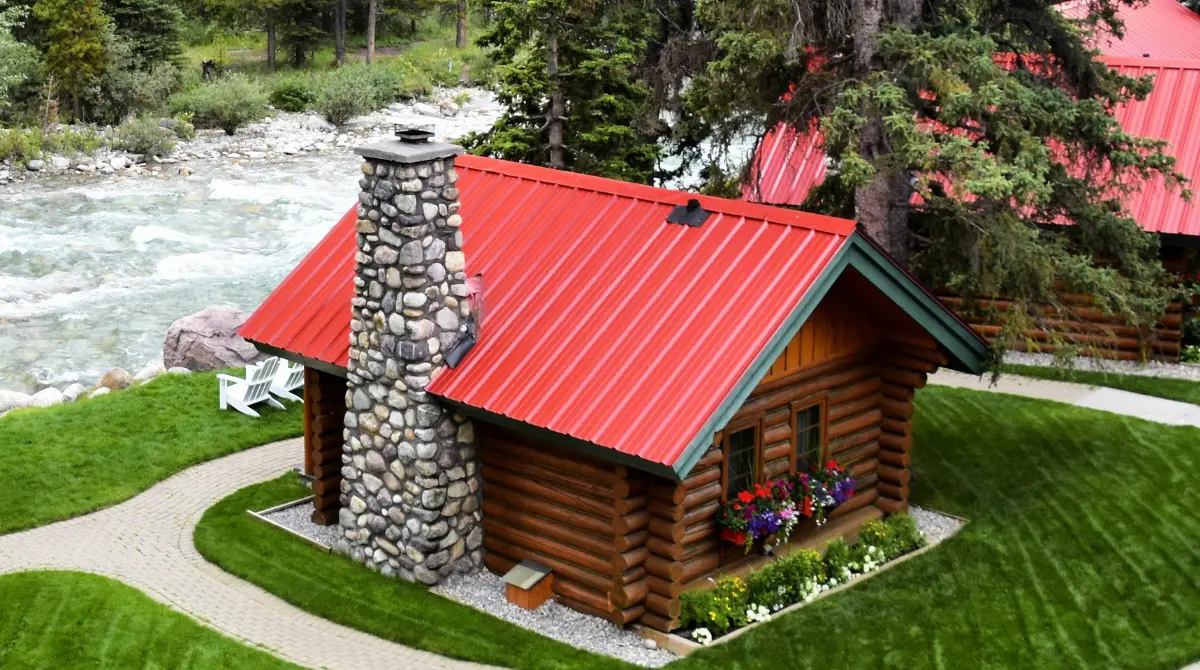 Charming small wooden house with a simple roof design in red and white.