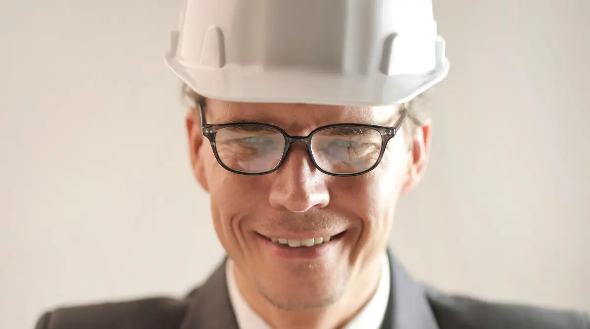 an architect smiling, showcasing a positive and confident expression