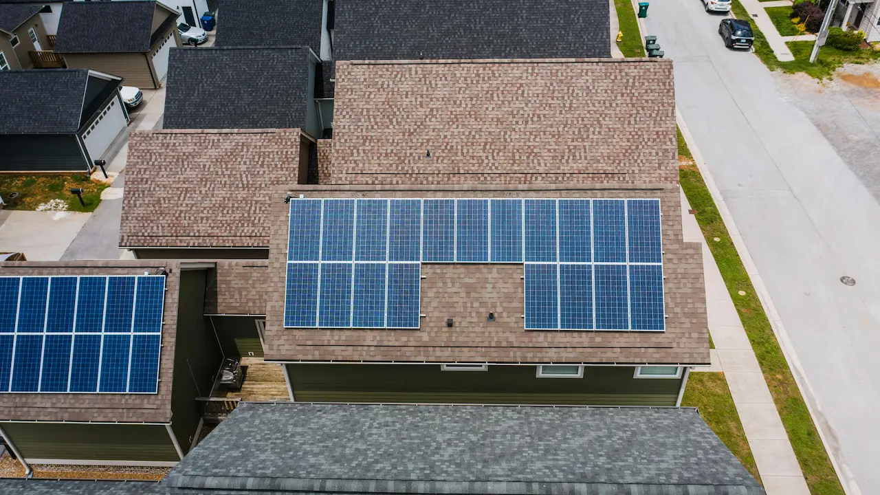 Solar panels installed on the tiled roof of a house, enhancing energy efficiency.