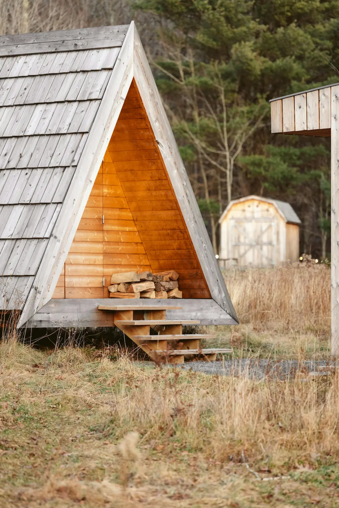 A vernacular wood house nestled in nature, showcasing traditional building materials.