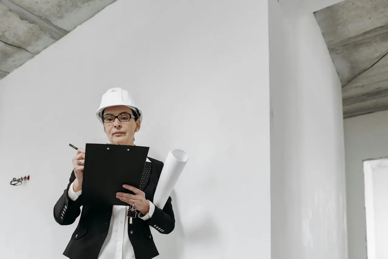 An architect on-site overseeing a construction project, managing plans, and ensuring quality.
