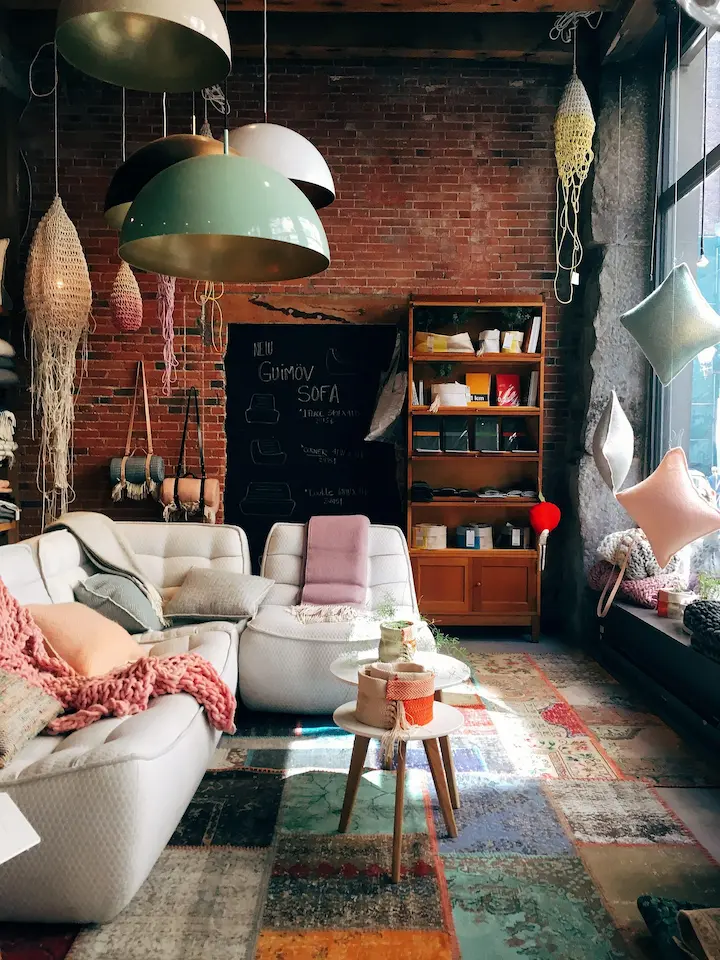 Industrial-style living room featuring a red brick wall and modern furnishings.