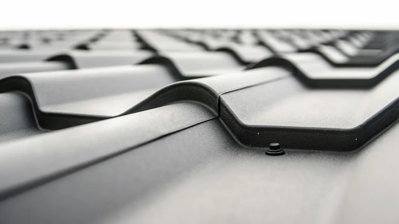 Close-up of a modern gray iron sheet roof with sleek, durable metal panels.