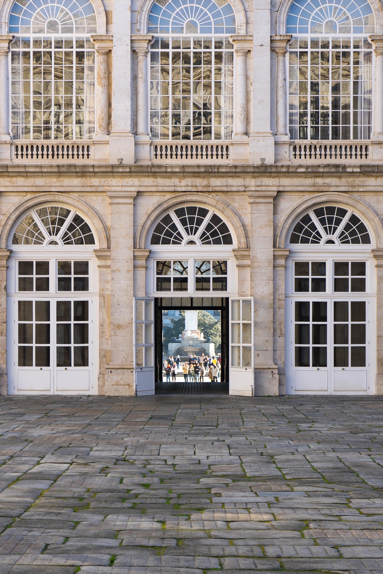 A Federal-style palace facade featuring classic windows and architectural symmetry.