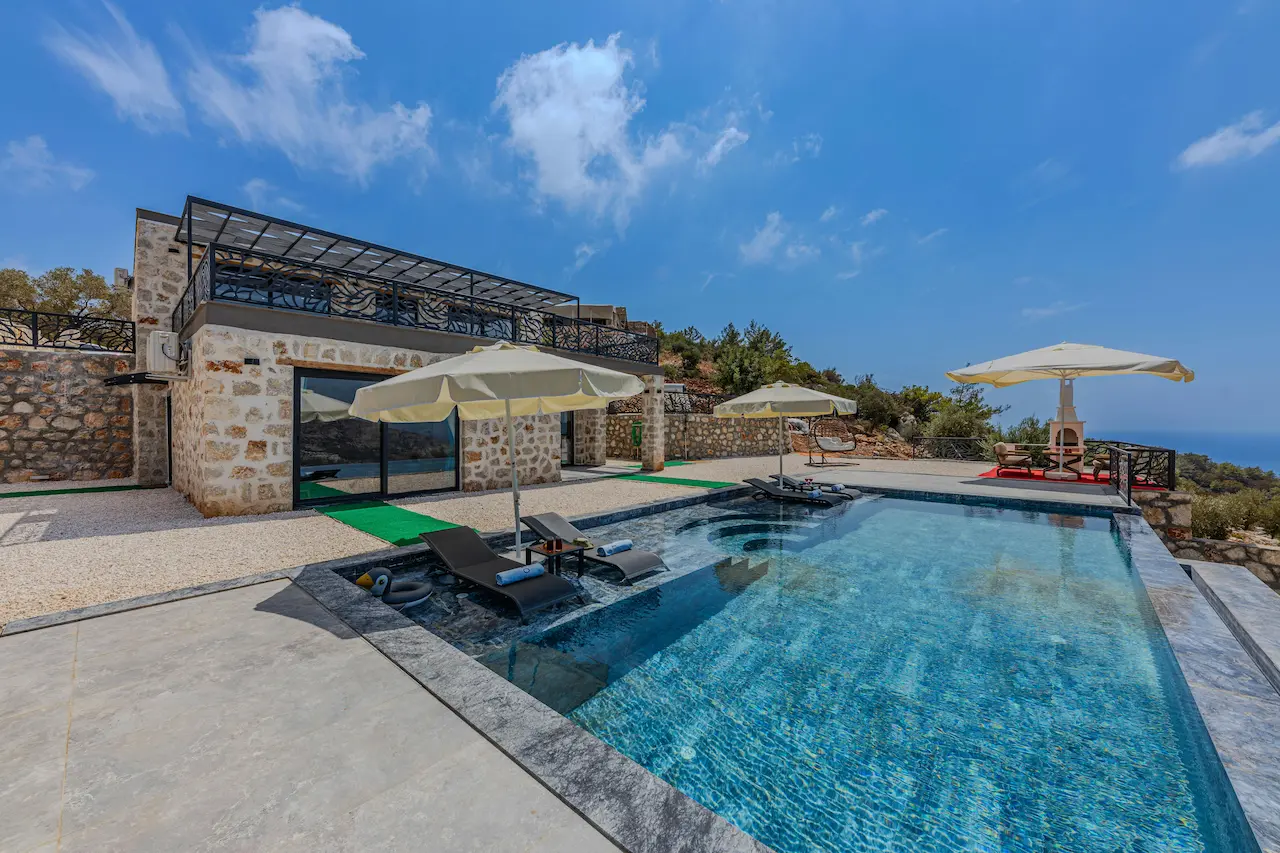Exterior of a modern custom house with stone walls, showcasing a sleek, contemporary design.