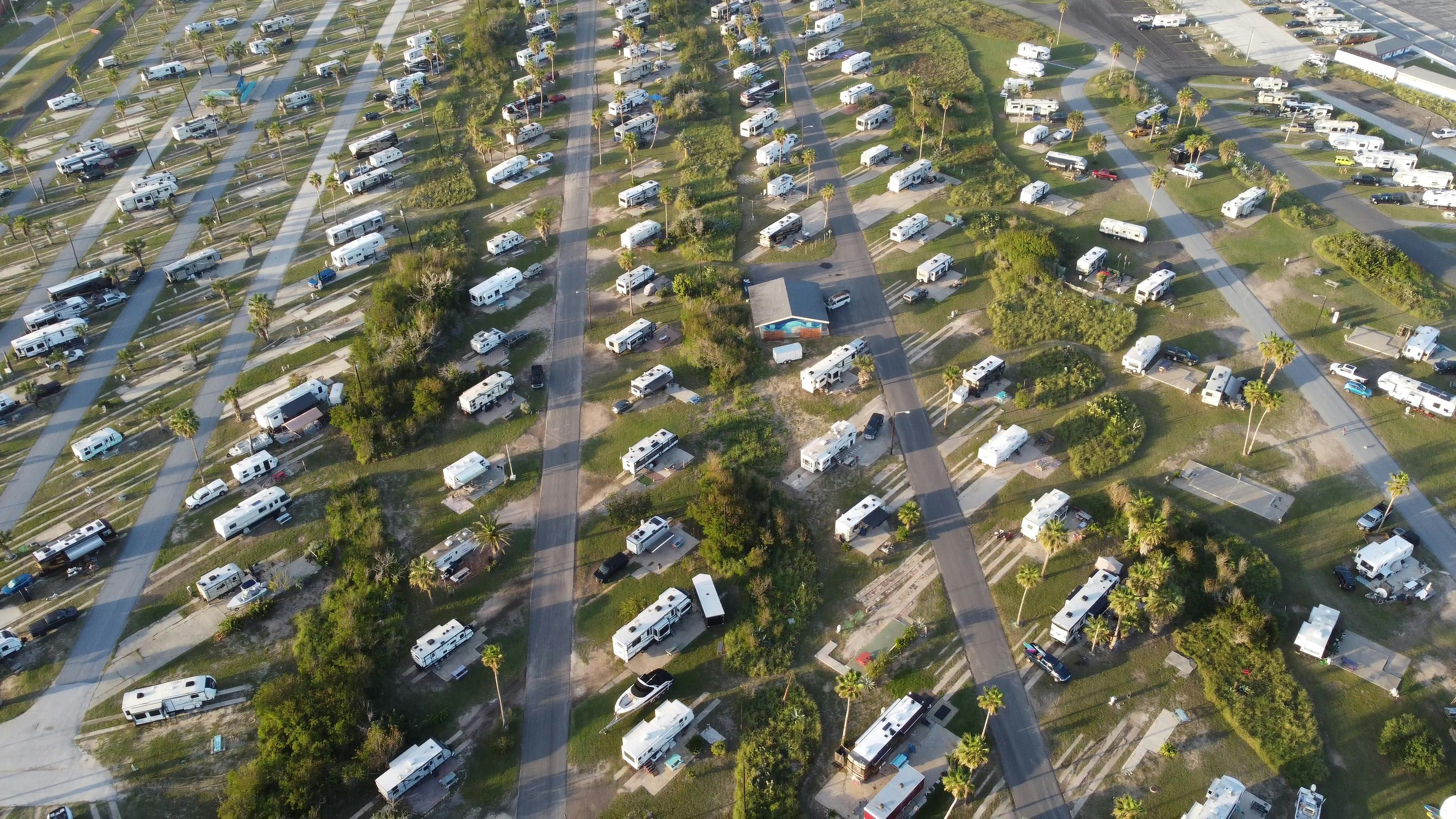 Aerial view of campers in a car park, featuring Scamp, Casita, and Oliver fiberglass RV trailers.
