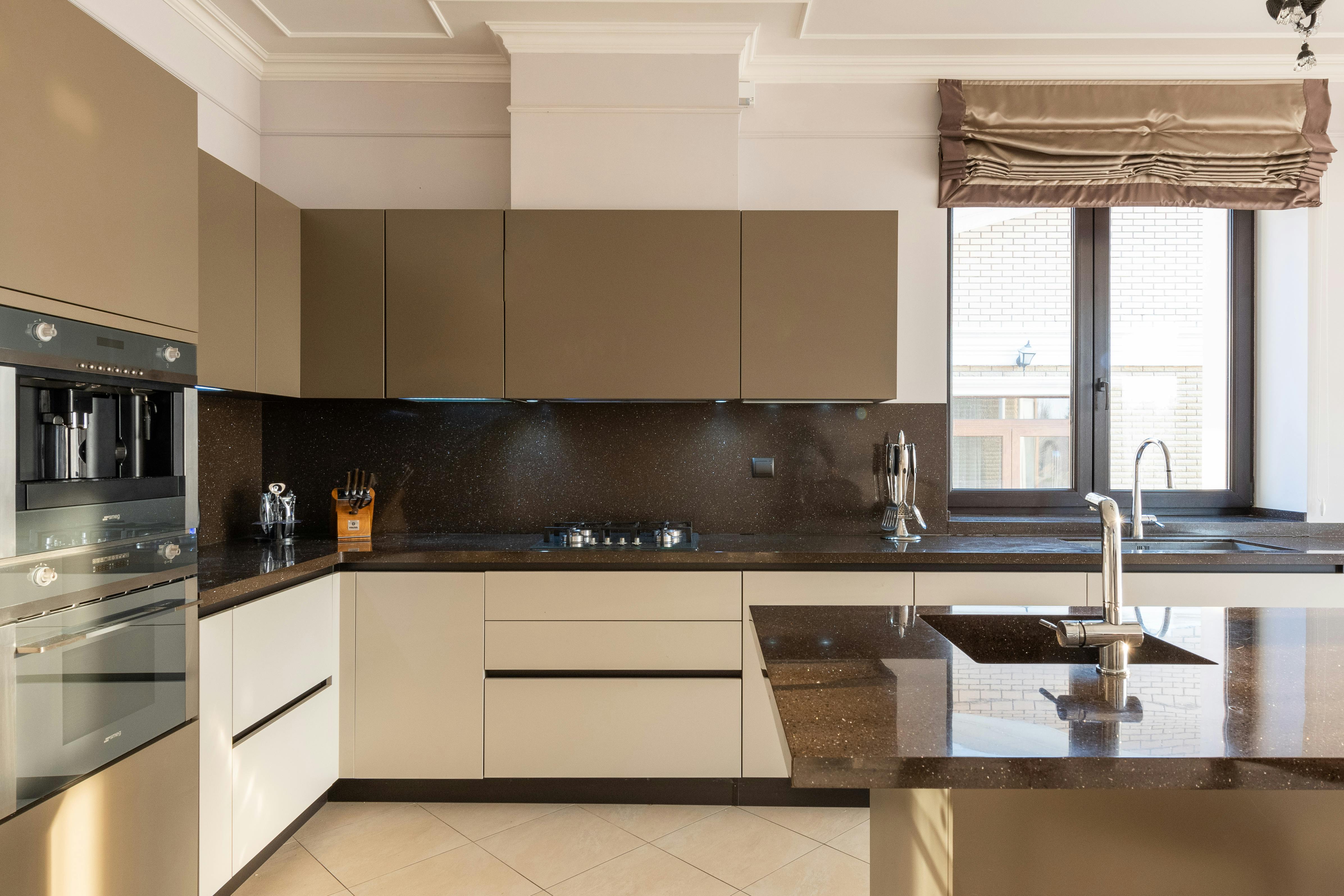 Modern kitchen with cream cabinets, neutral walls, and soft accent colours.