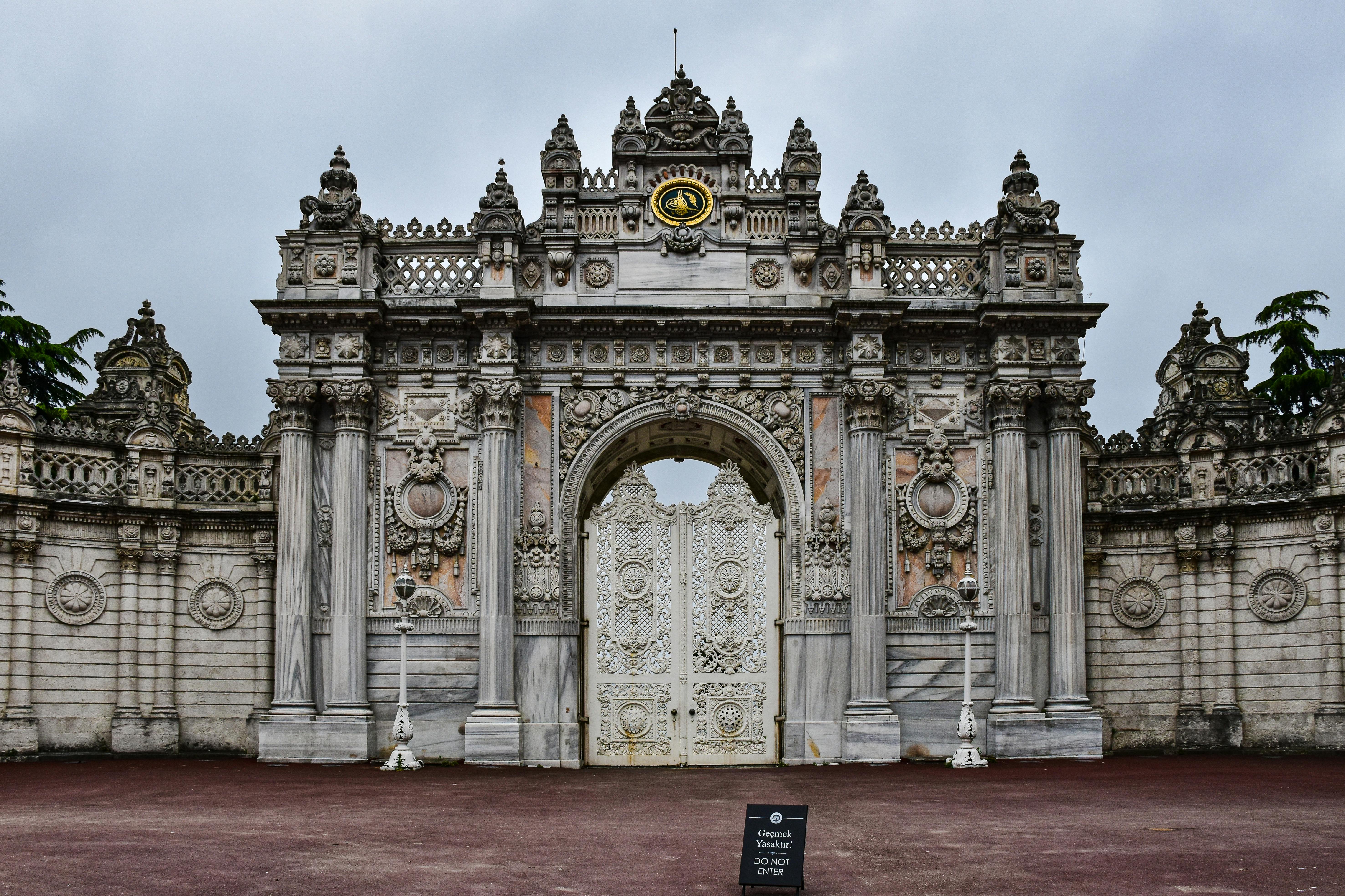 Gate of Dolmabahçe Palace with ornate stonework.
