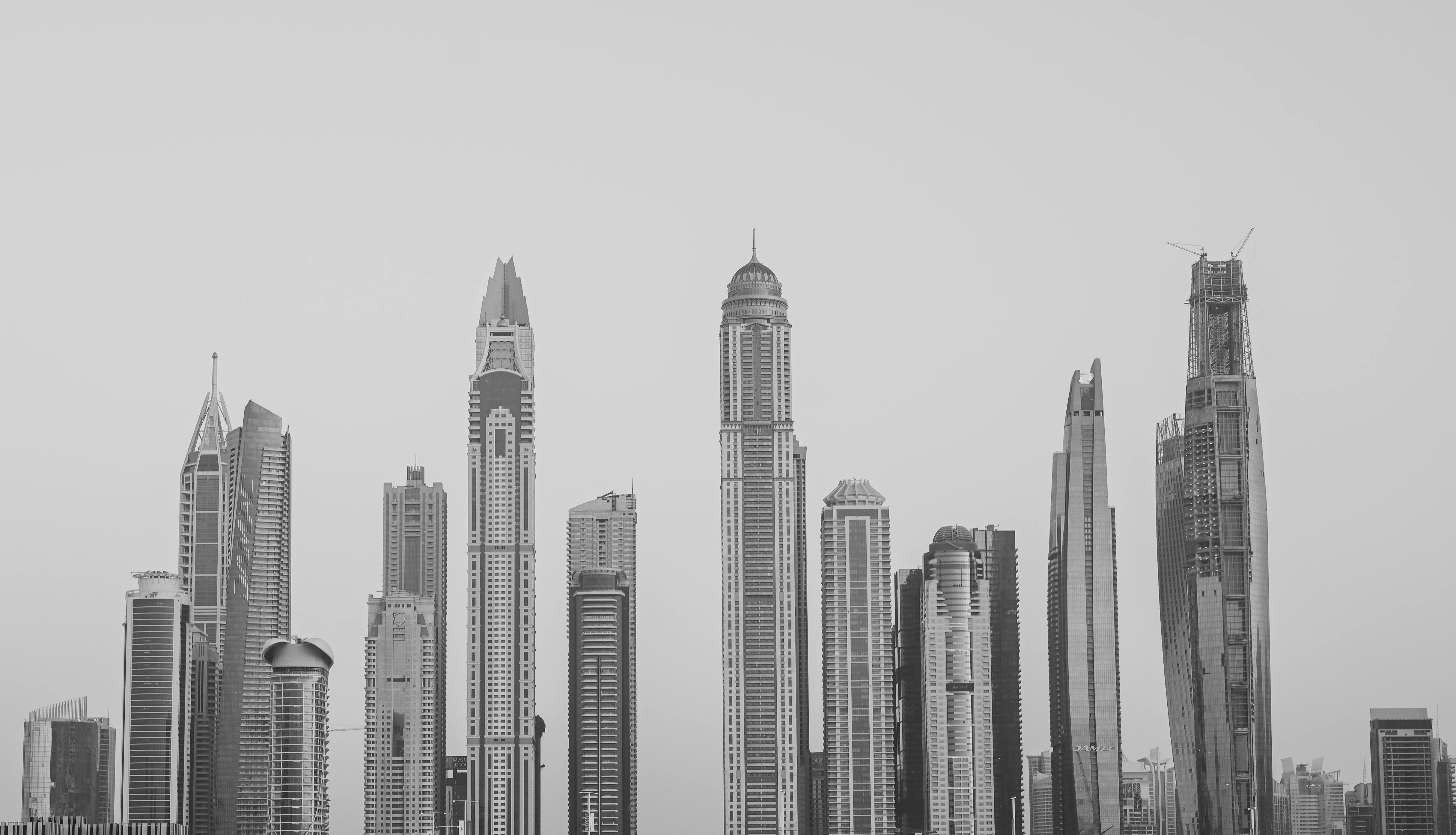 Black and white view of Dubai's iconic skyscrapers towering over the city skyline.