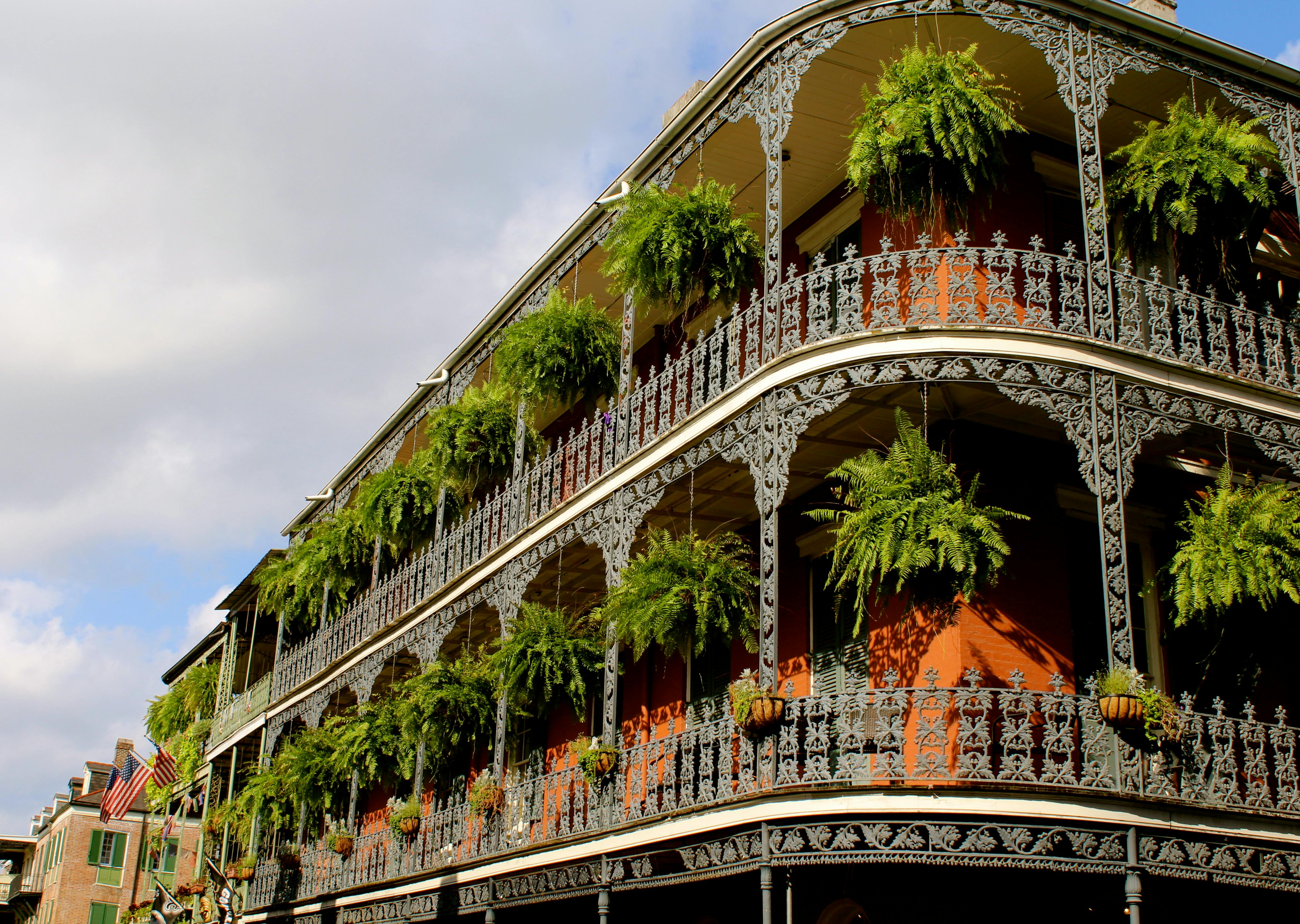 Colonial-style buildings in the French Quarter of New Orleans, featuring balconies and narrow streets.
