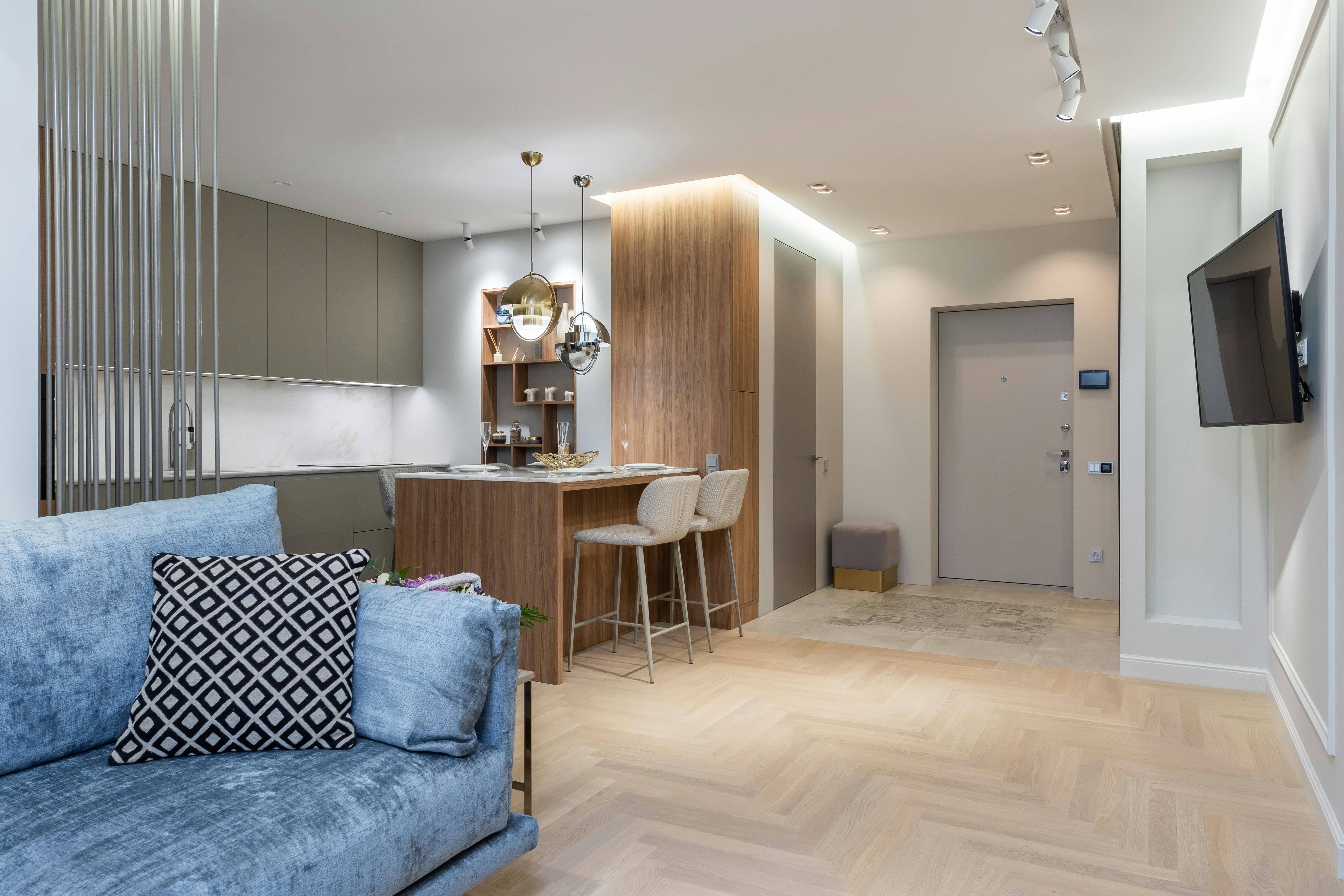 House interior with a modern kitchen painted in Behr Silver Drop, a whispery gray that complements the sleek, contemporary design.