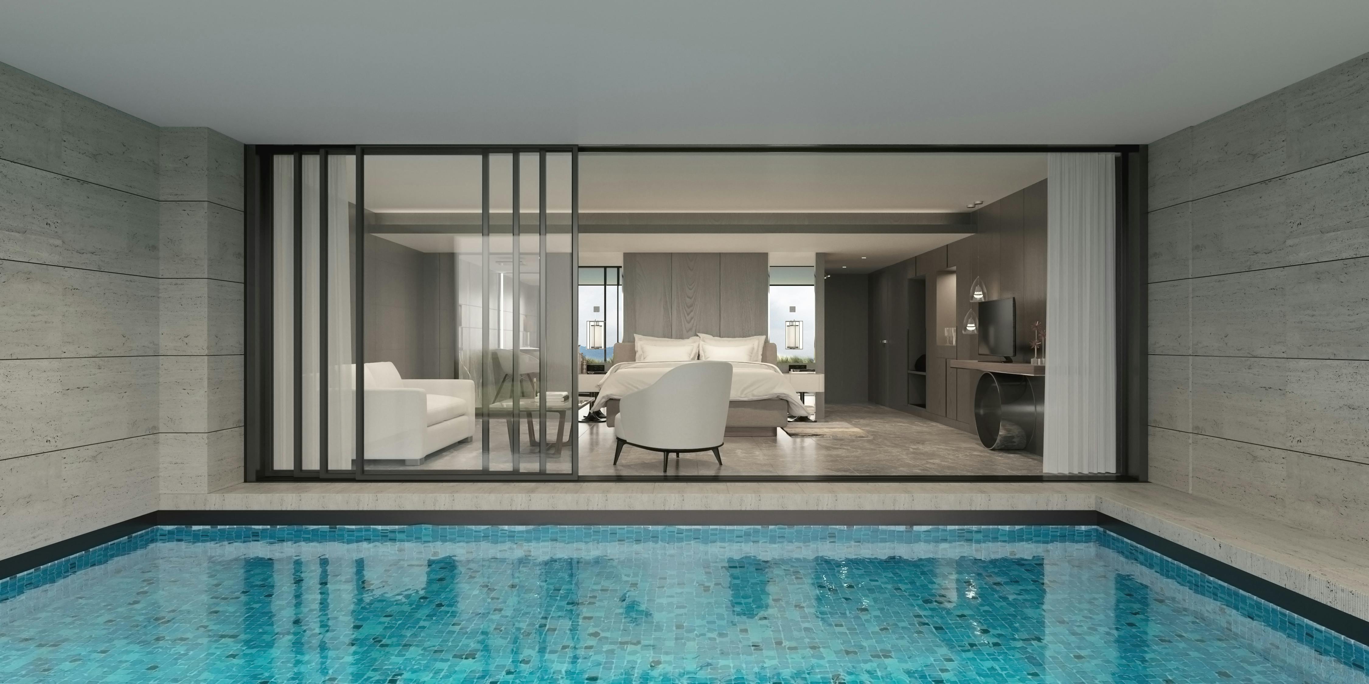 Modern minimalist home in Bodrum with indoor pool facing large window and living room.