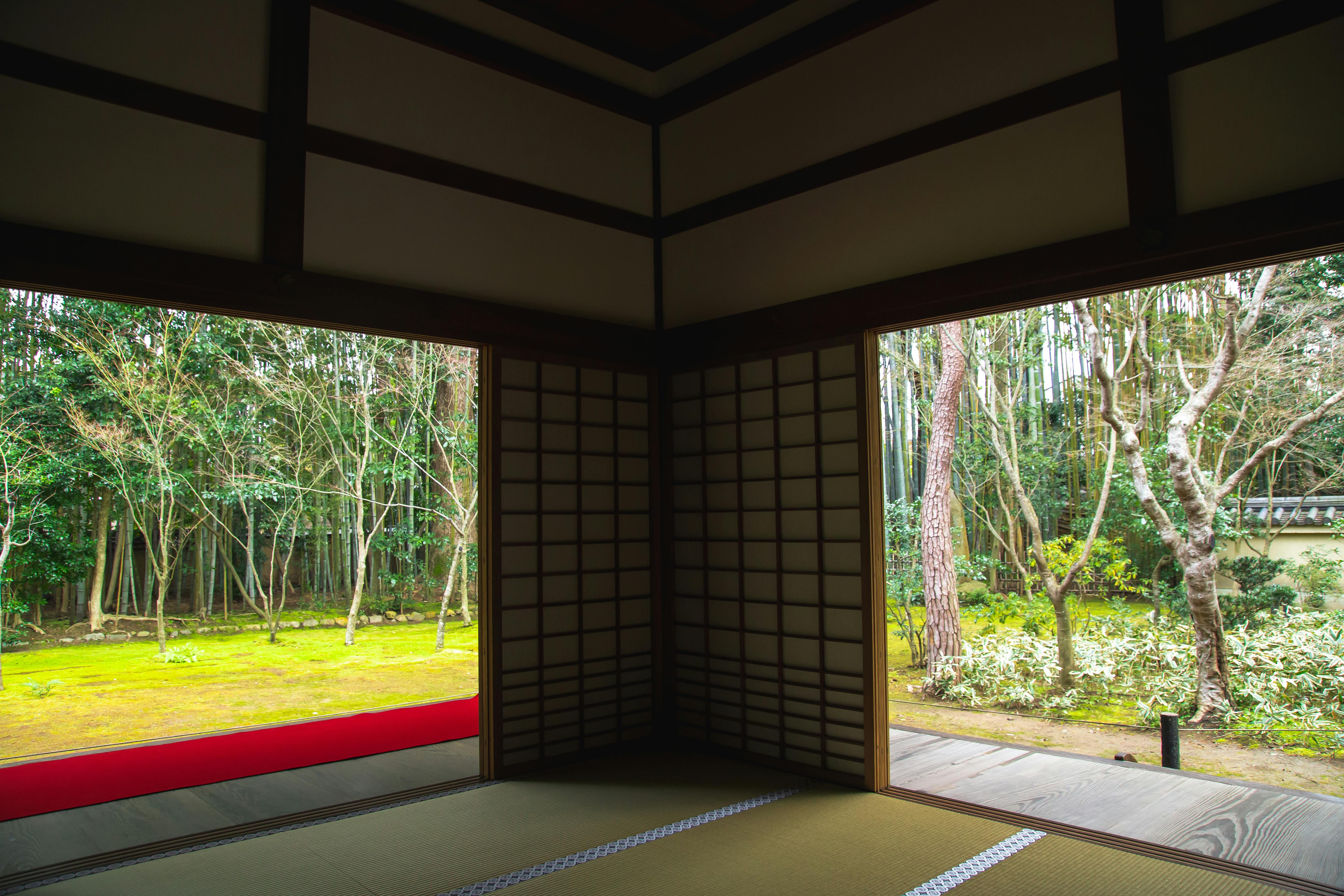 Interior of a spacious house in Kyoto, overlooking a green meadow with trees.