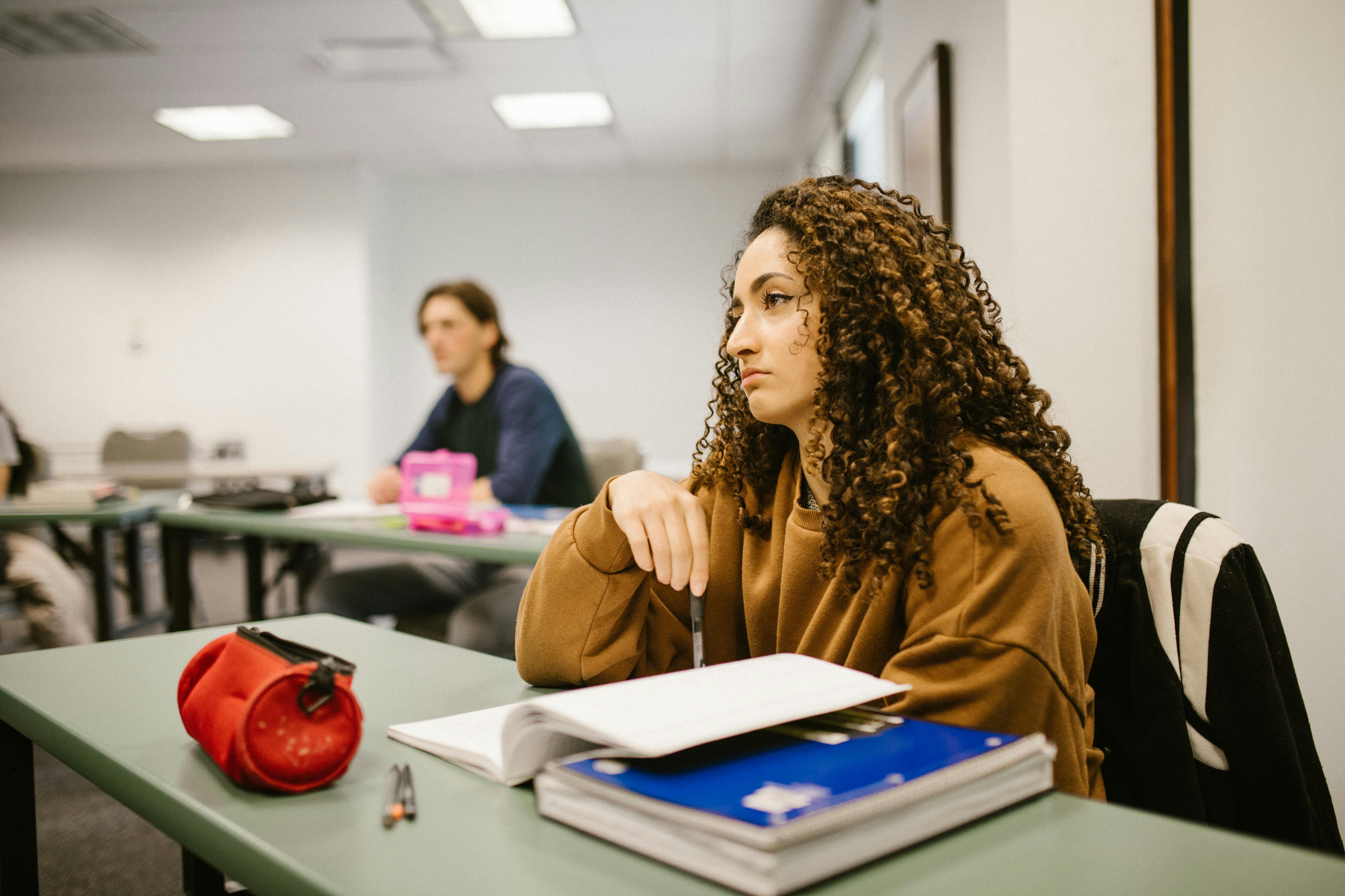 Female student stressed during an exam, showing signs of anxiety and pressure.