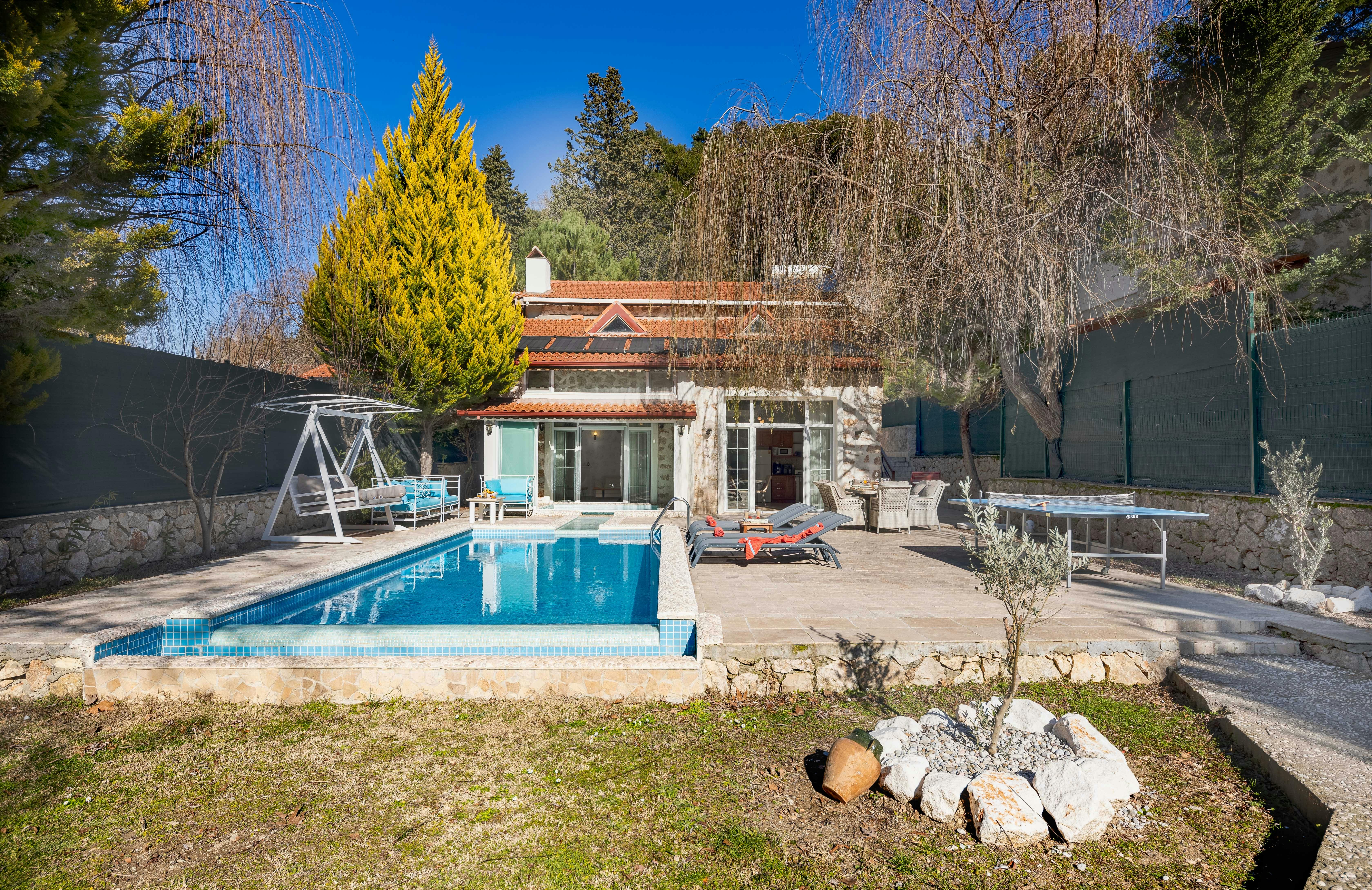 Tiny house with a pool and house garden.