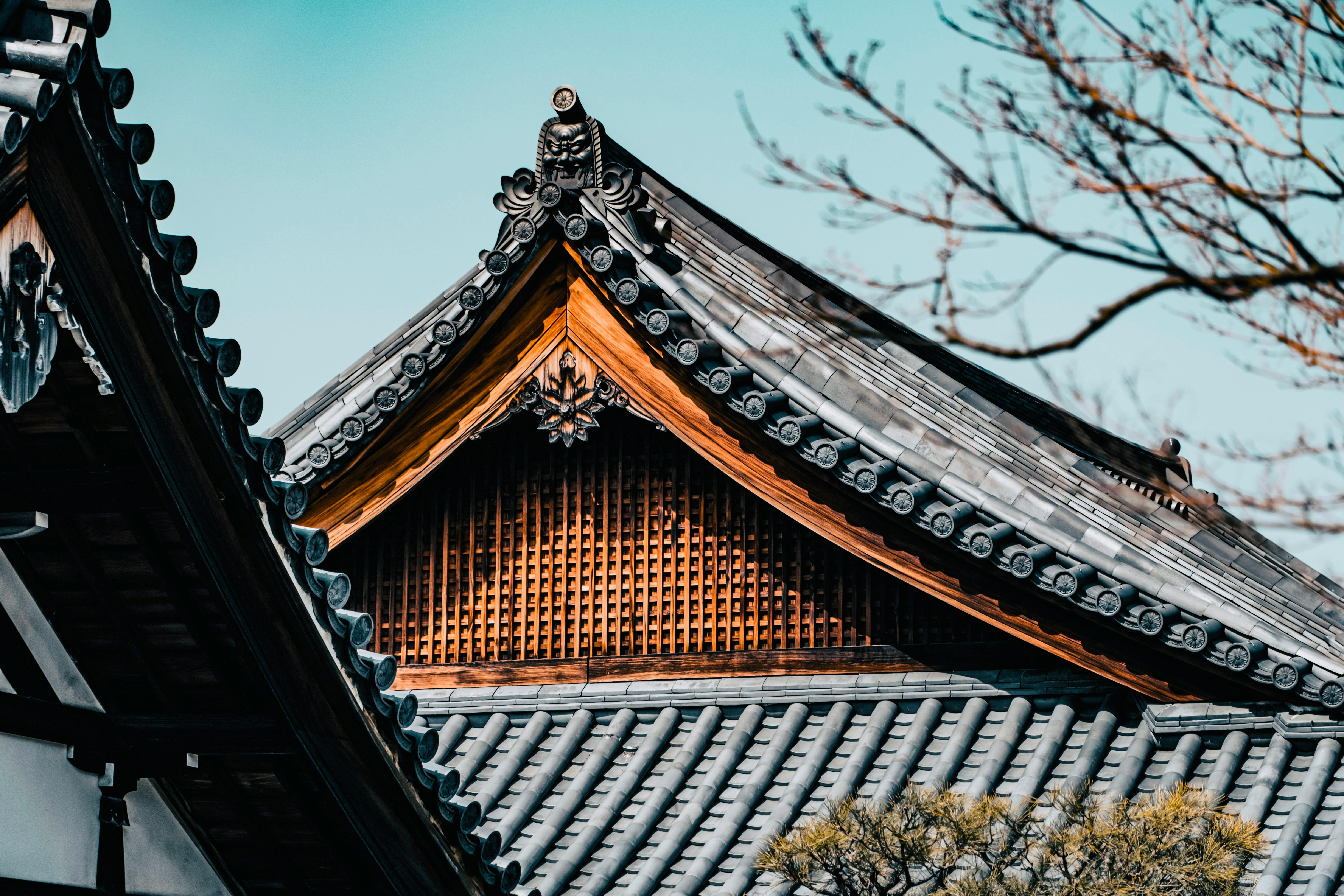 Traditional Japanese roof with intricate design and wooden structure.