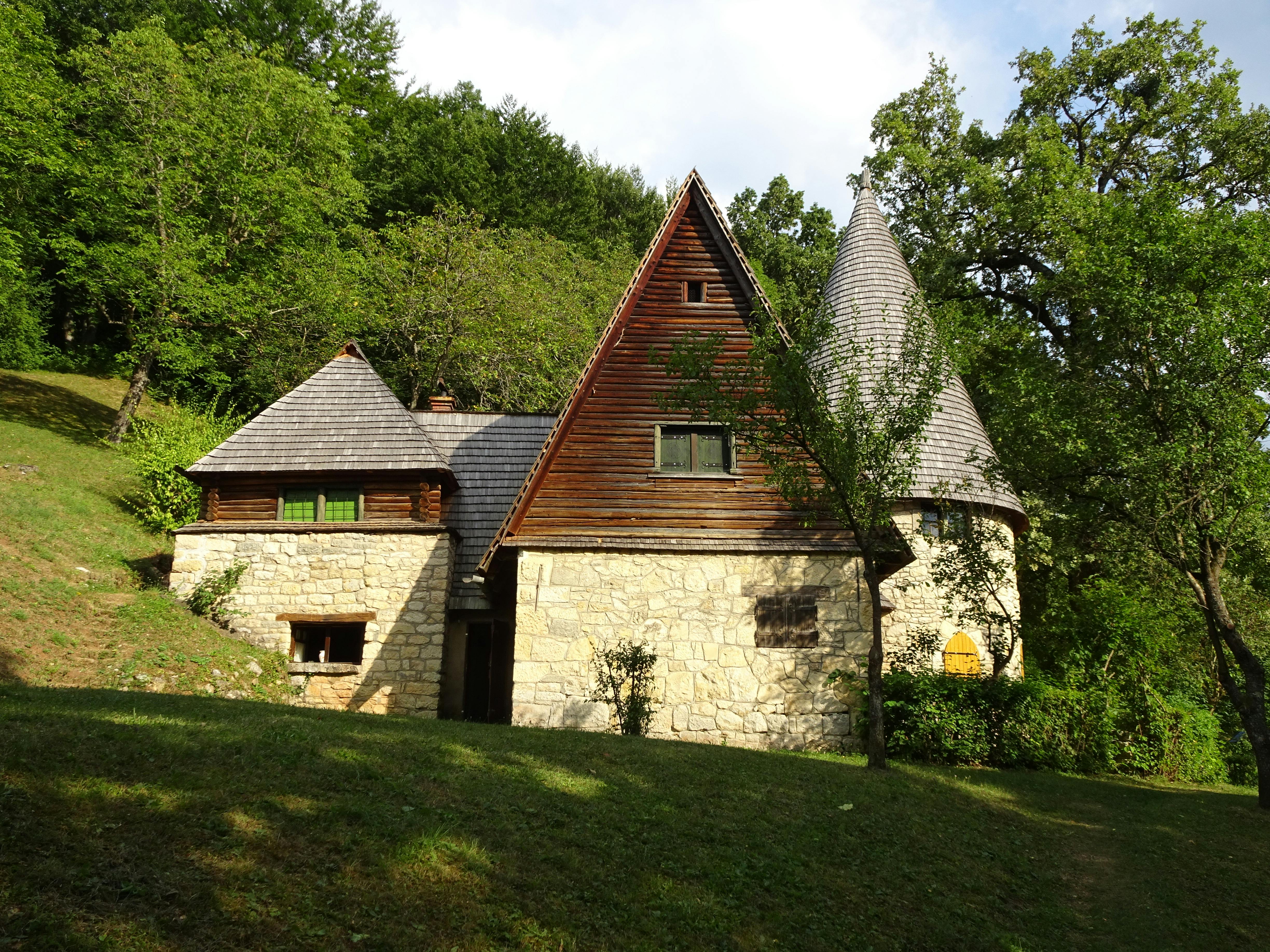 1850s storybook-style house in wooded setting.