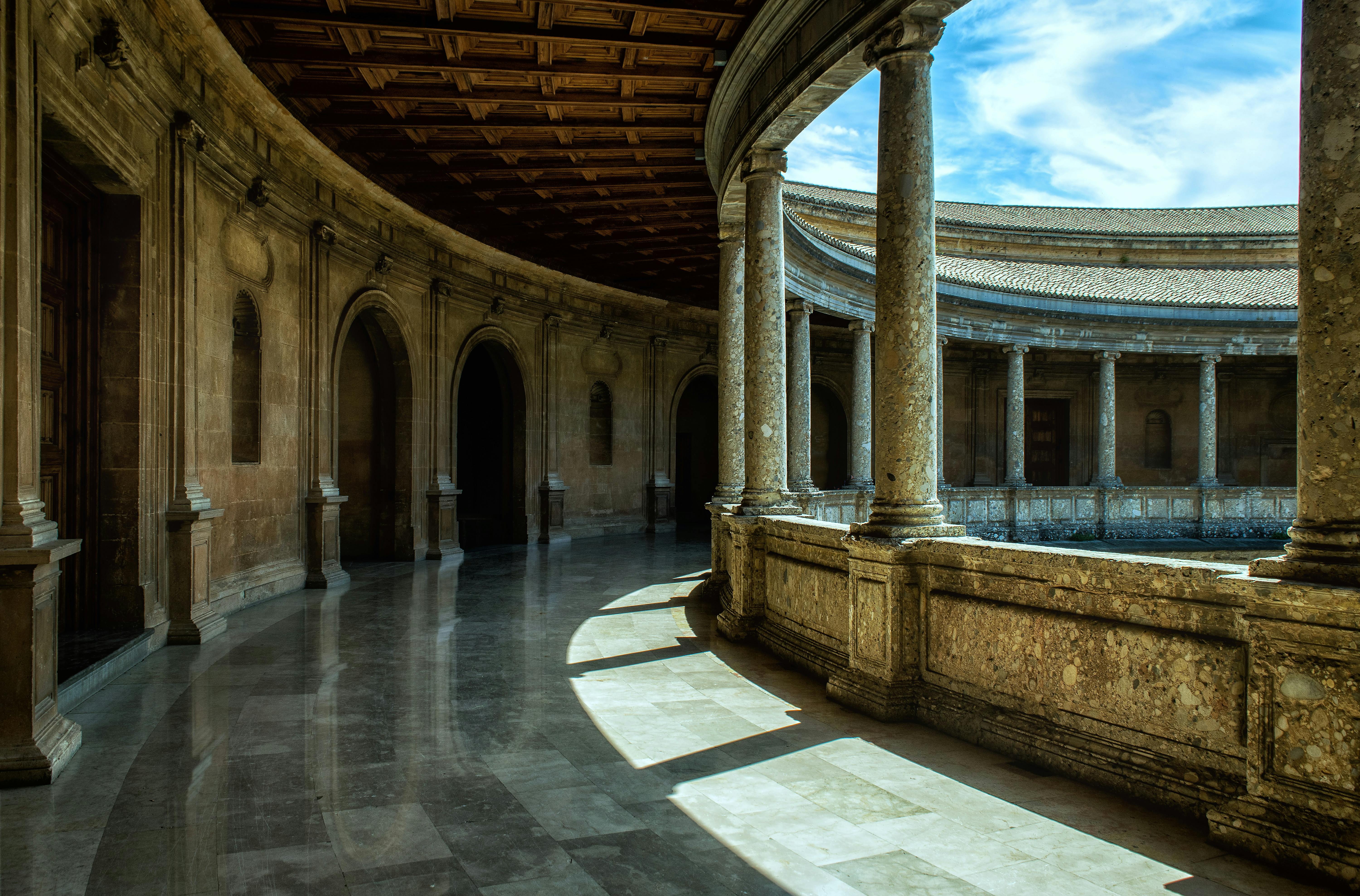 Majestic courtyard (sahn) at the Alhambra with intricate arches.