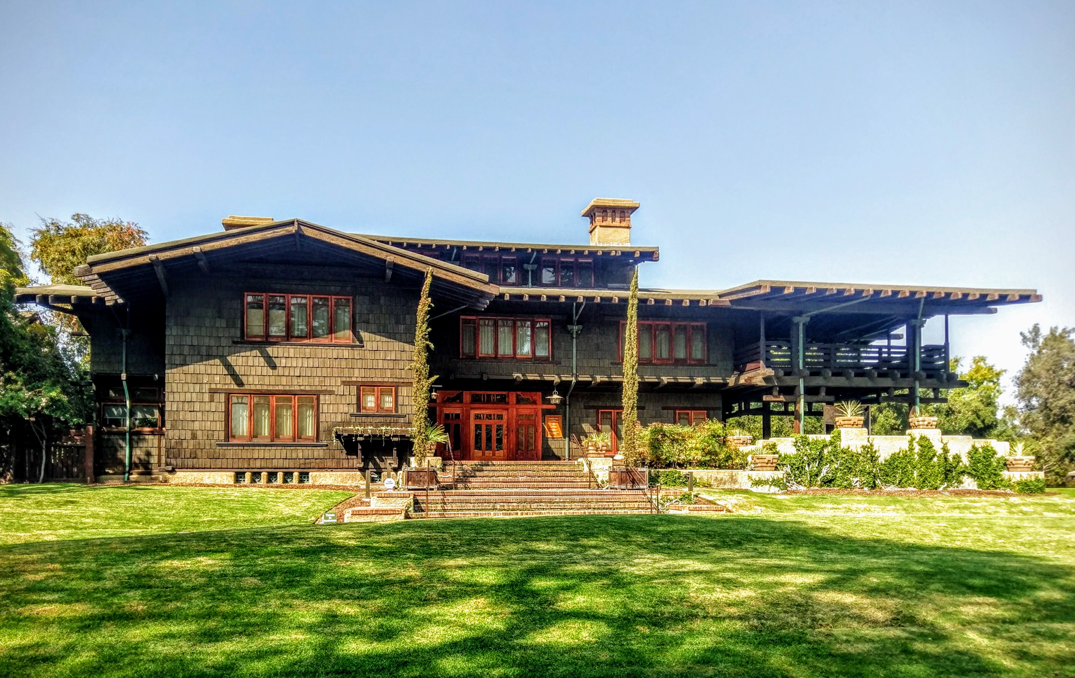 Exterior view of Pasadena Gamble House, a classic Craftsman bungalow with detailed woodwork and low-pitched roof.