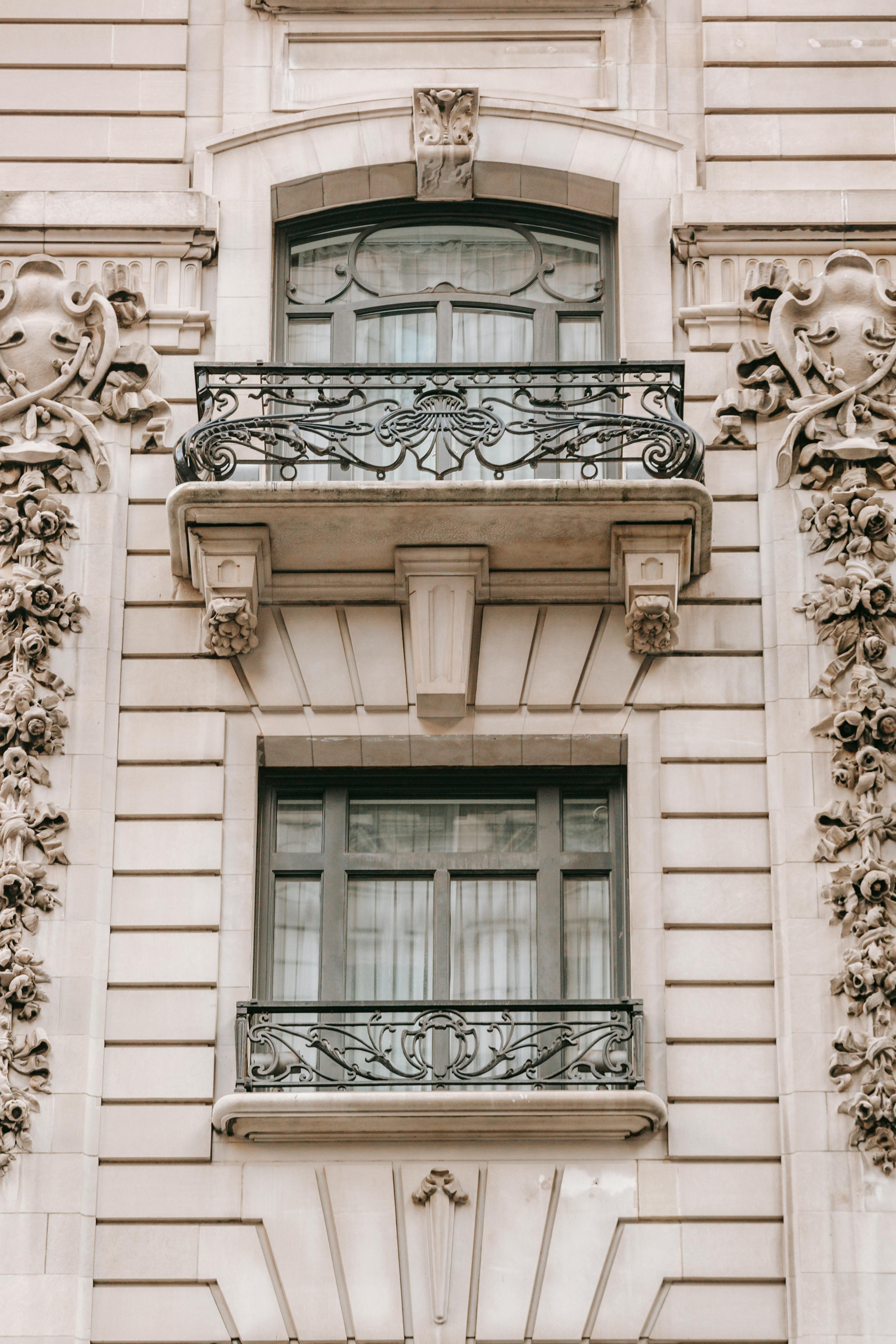 Classic Italian-style stone facade with arches and traditional detailing.
