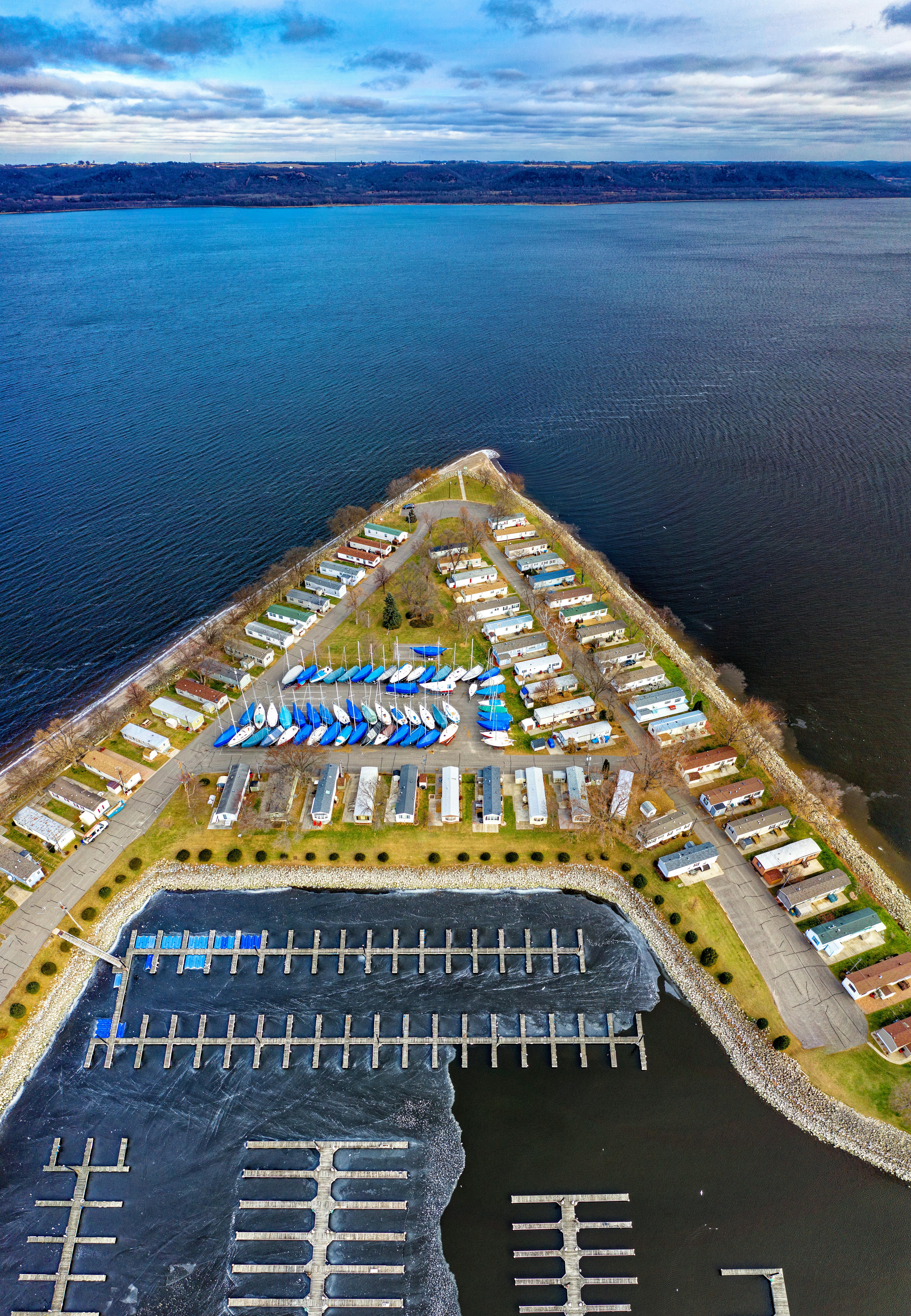 Bird’s-eye view of single-wide mobile homes near the water in Lake City, MN, showing efficient community layout in a scenic lakeside setting.