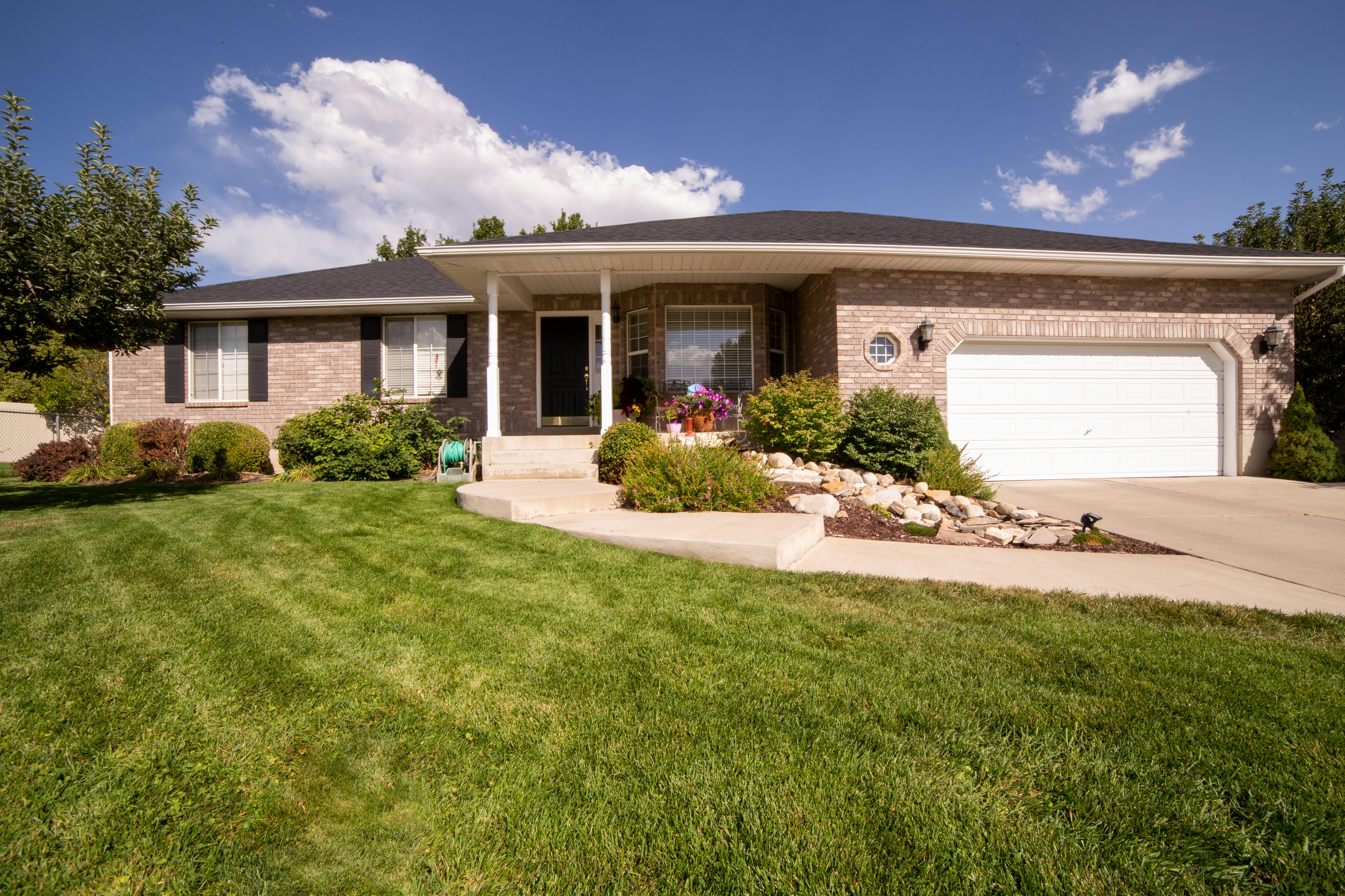 Large modern one-level house featuring stone construction and spacious design.
