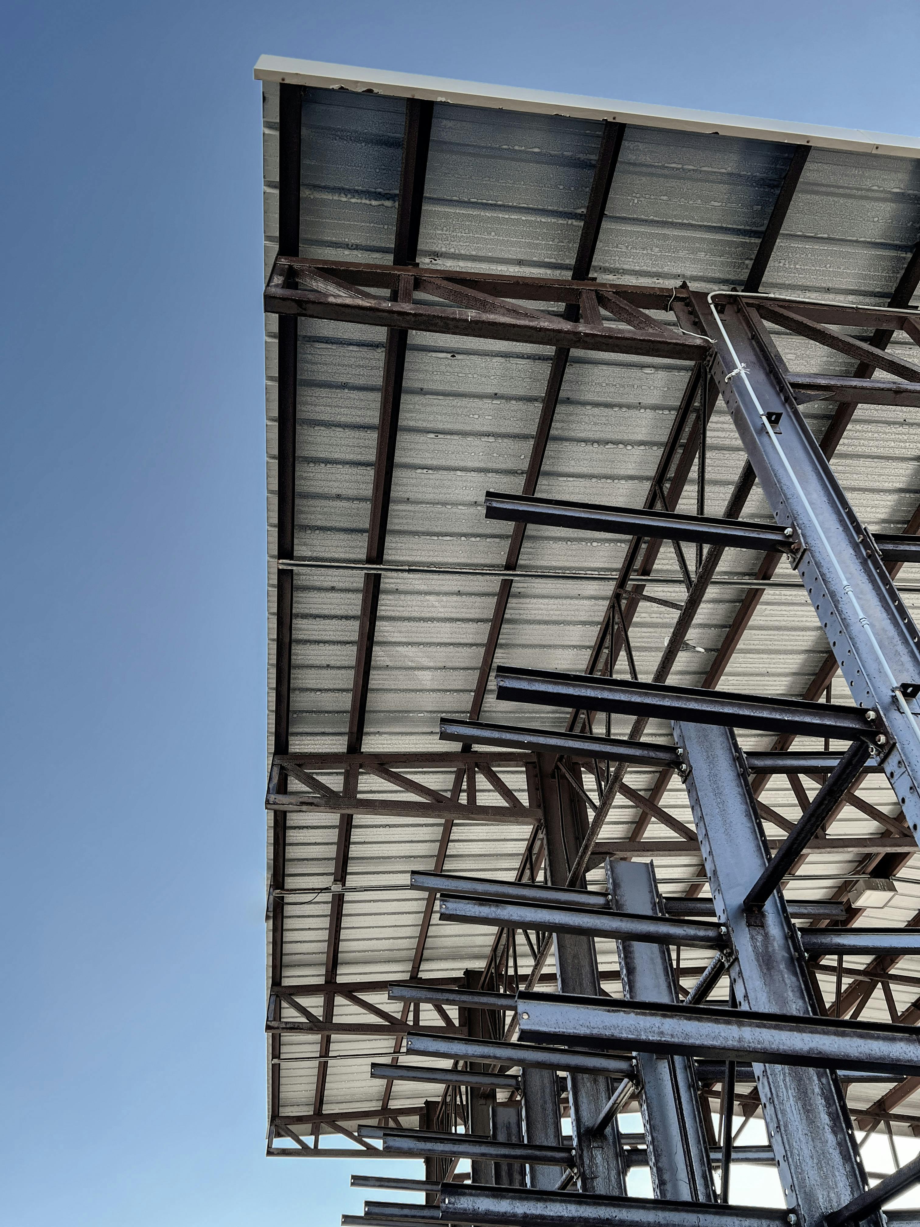 Steel truss framework supporting the roof of a commercial building under construction.