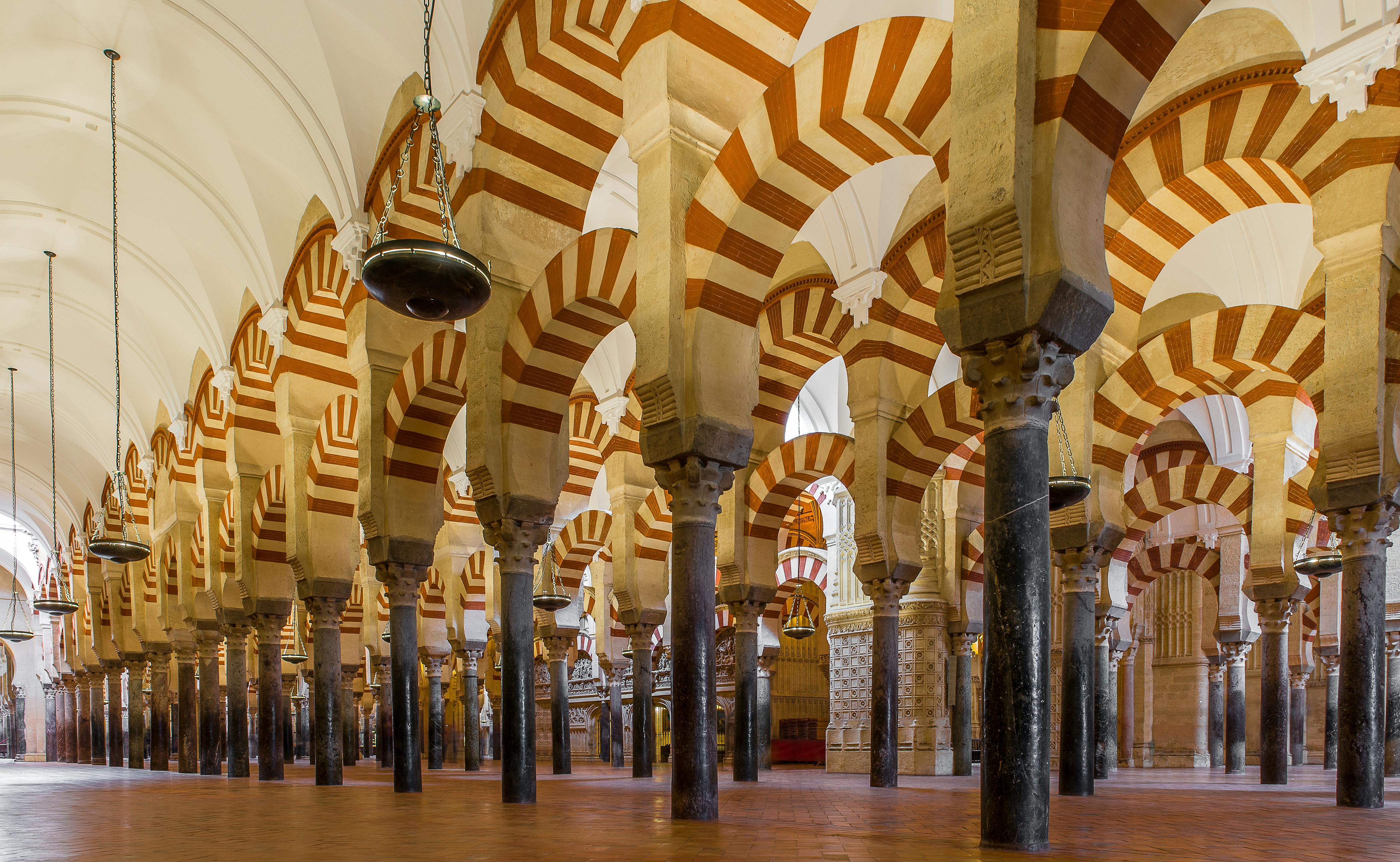 Horseshoe arches with red and white stripes in the Mosque of Córdoba.