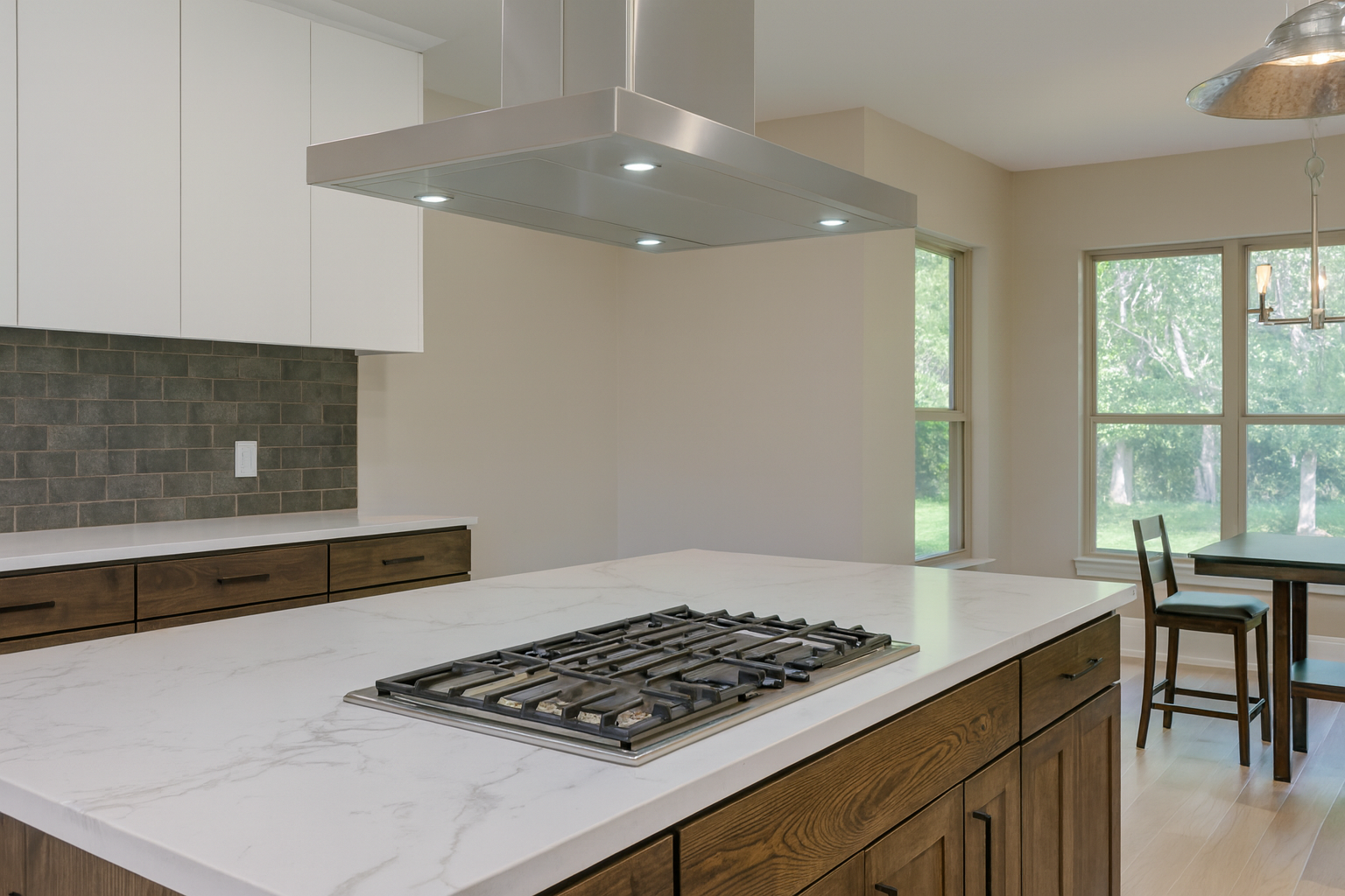 Kitchen with natural stone benchtop, modern wood cabinets, and updated flooring in an open, bright layout.