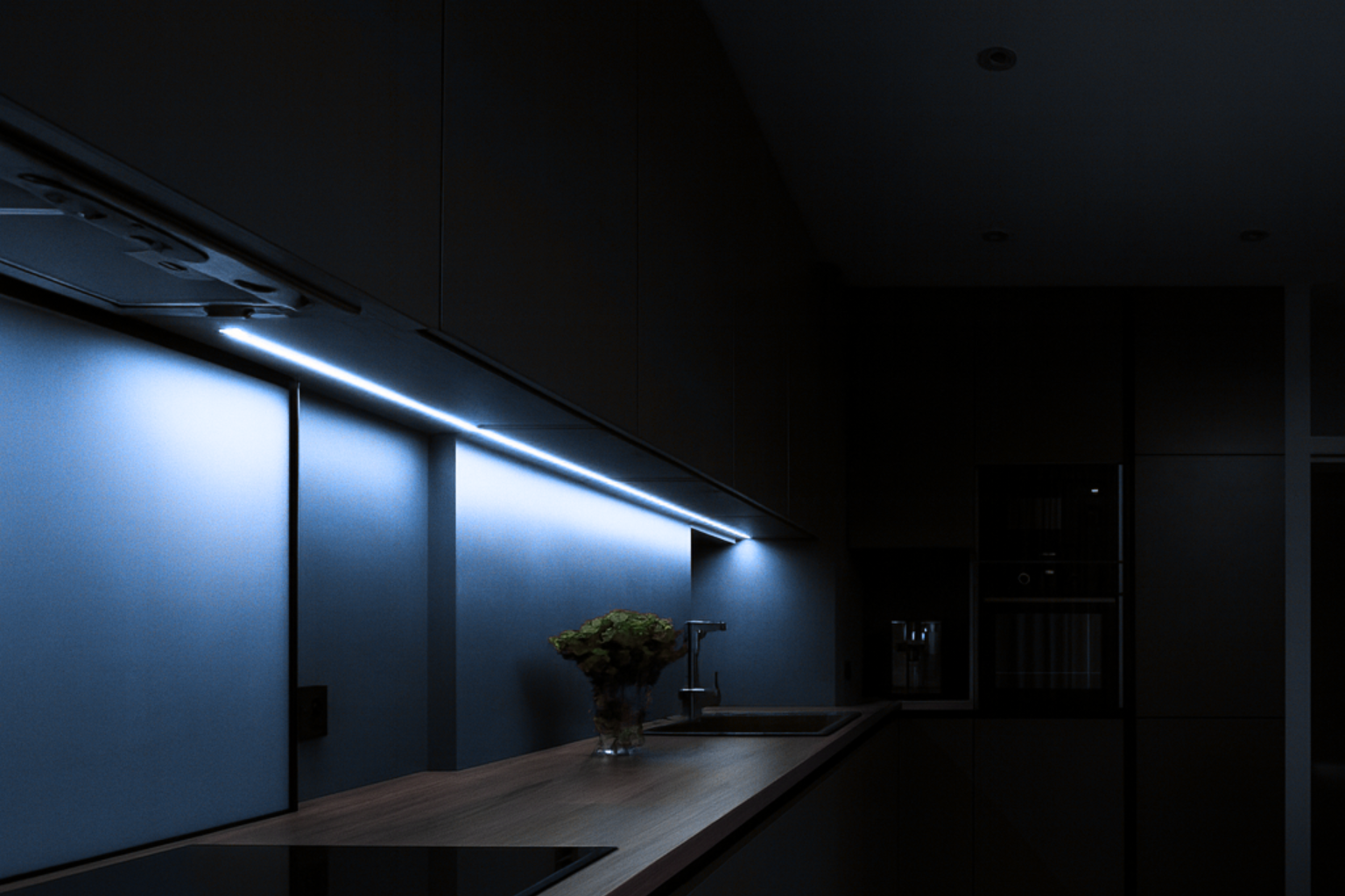 Modern kitchen with cool-toned under-cabinet LED lighting.