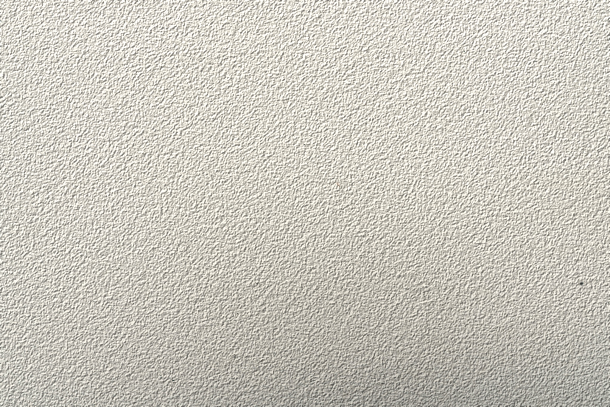 Stucco finish texture background showing subtle aggregate and plaster trowel pattern.