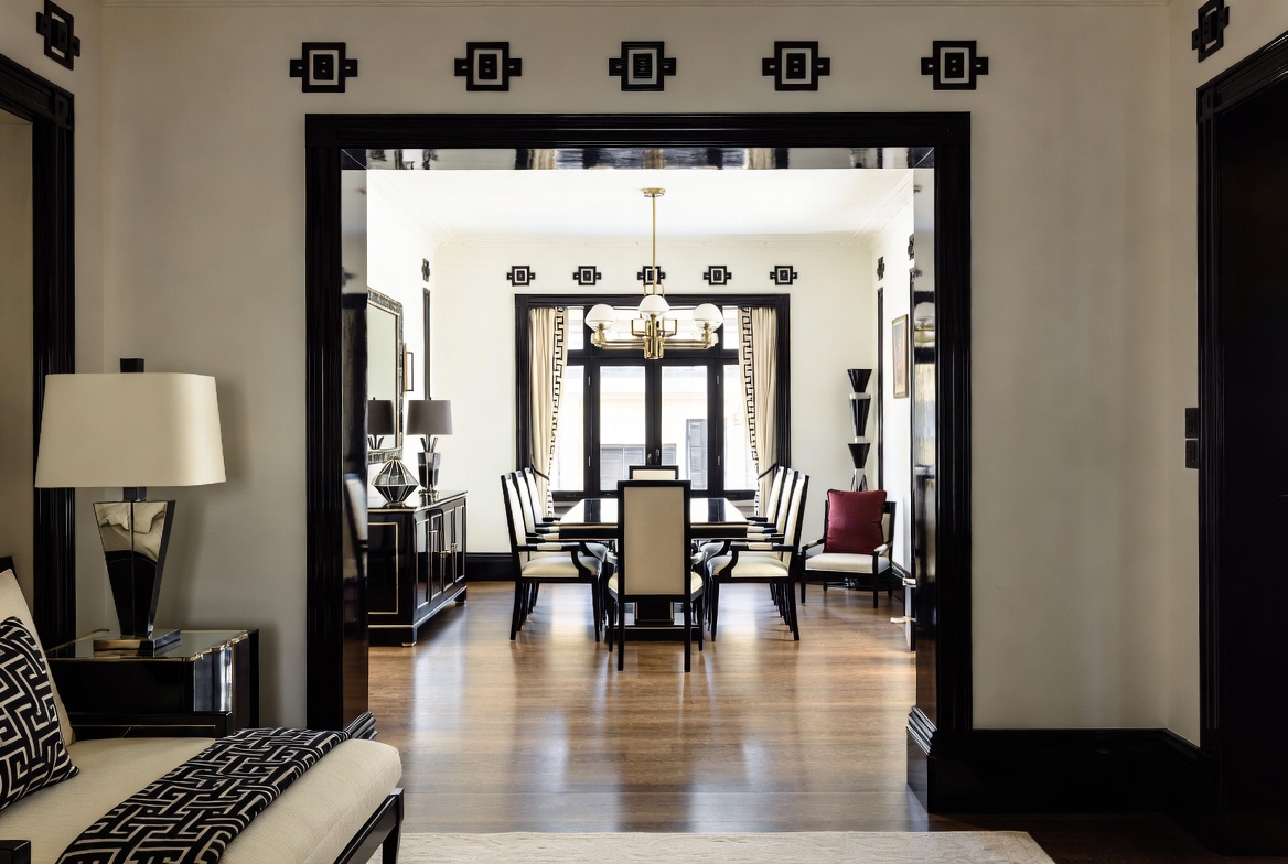 Art Deco-inspired interior with black trim, geometric detailing, and connected rooms flowing from one space to the next.