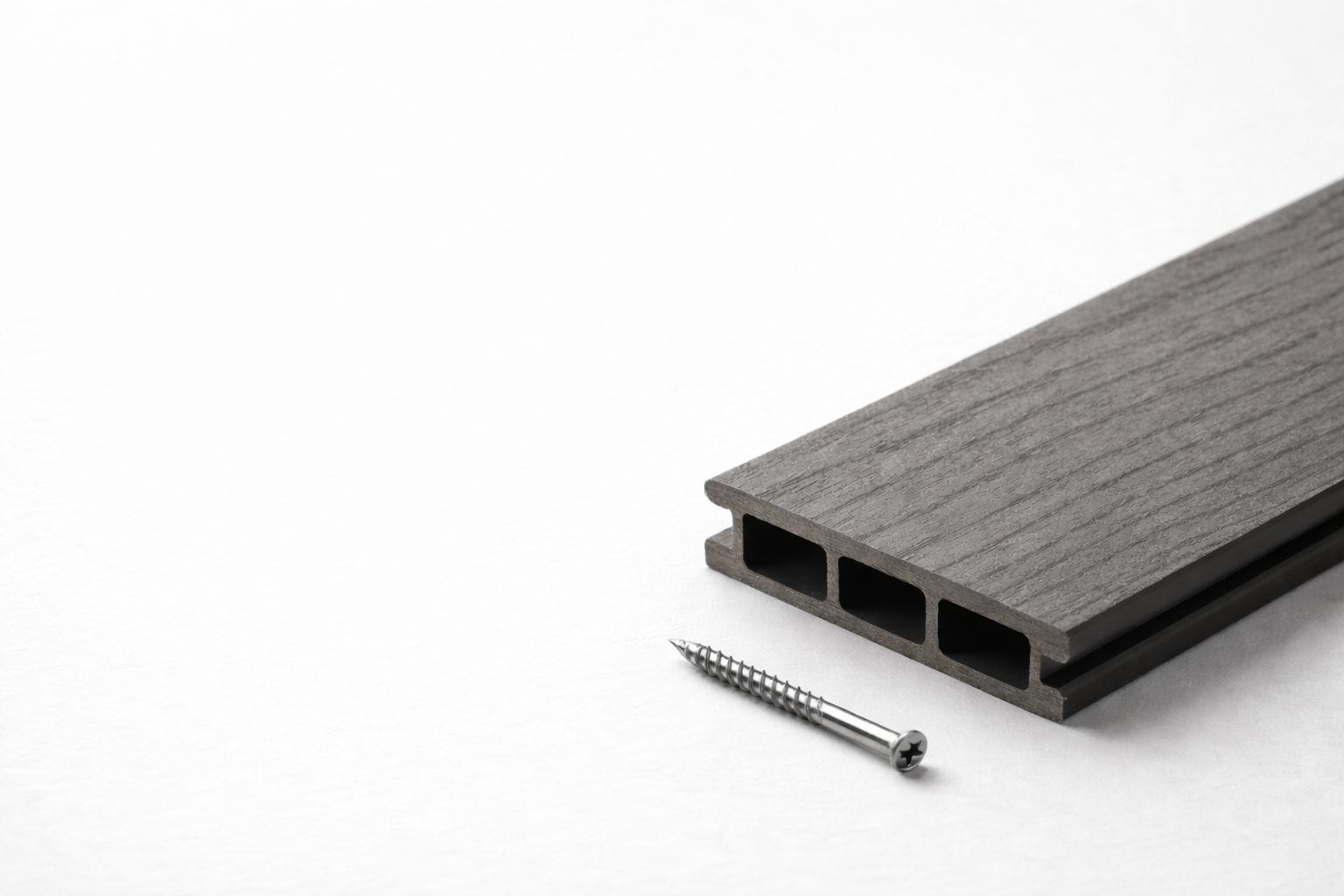 Composite decking FAQ cover image showing hollow-core board cross section and deck screw.