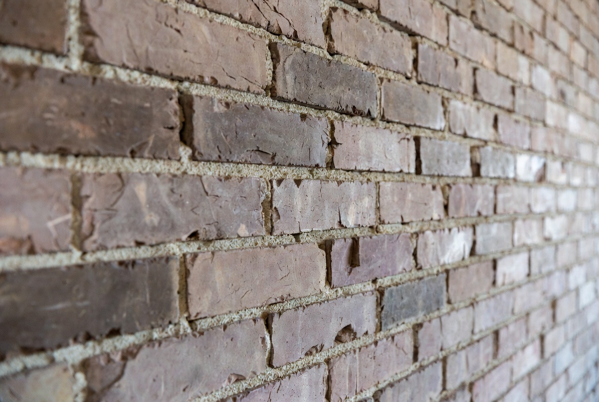 Authentic reclaimed thin brick exterior accent wall of a house.