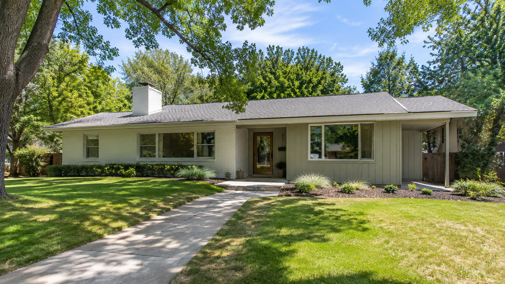 Updated 1960s ranch house exterior with low roofline, painted brick, vertical siding, simple entry, broad front windows, and restrained landscaping.