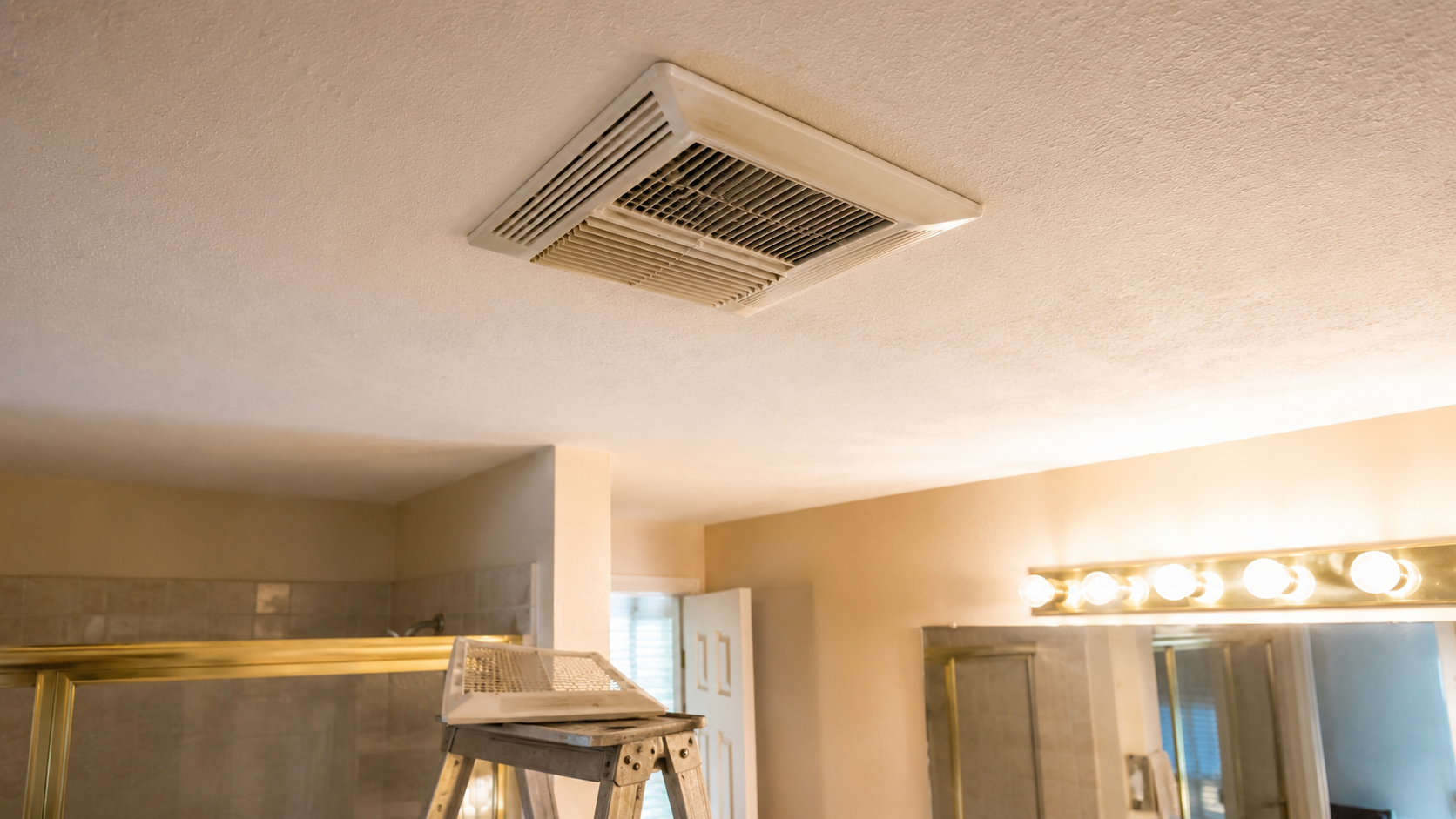 1990s bathroom ceiling fan and removed cover checked during remodel planning.