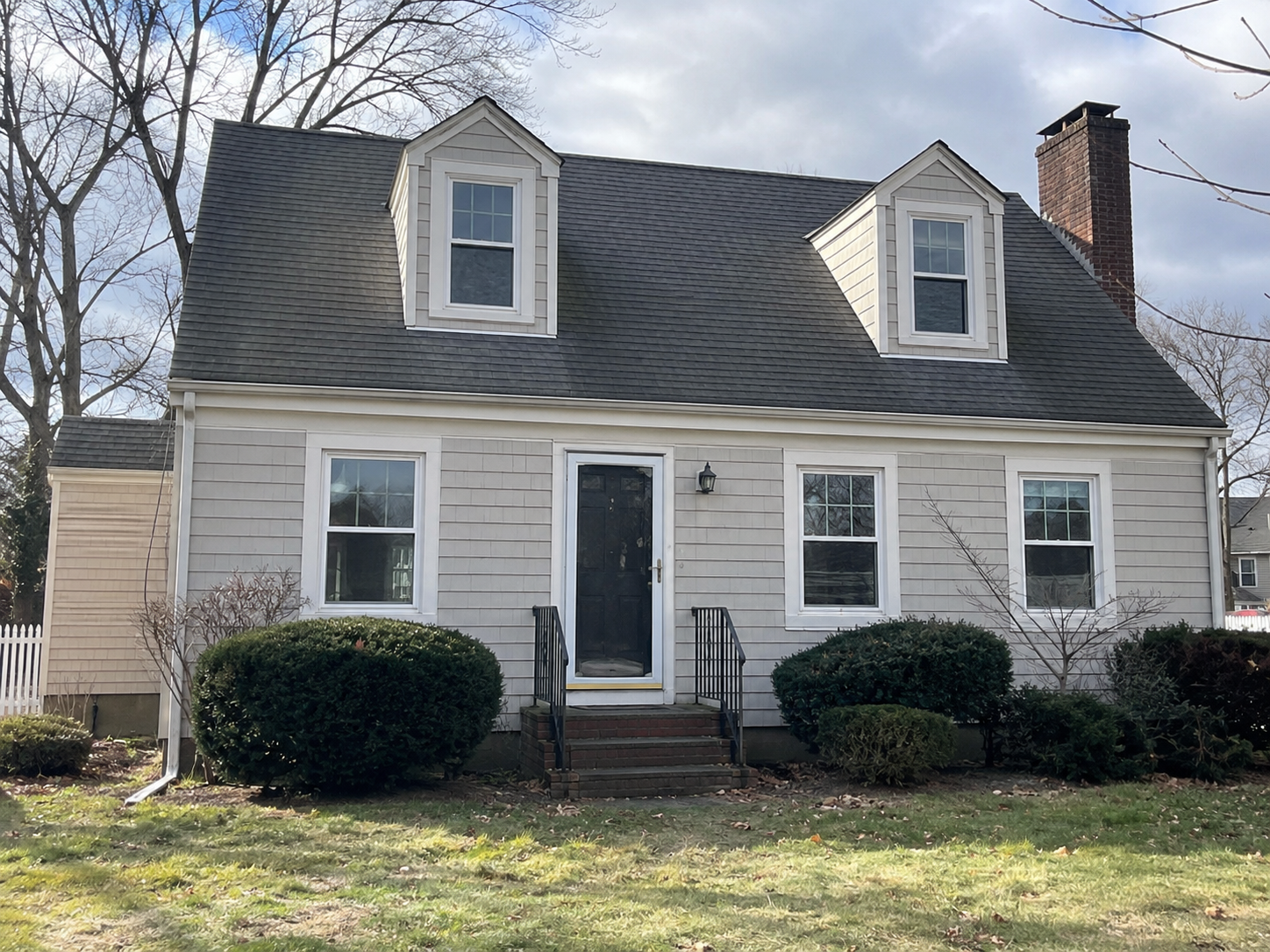 Cape Cod house with replacement windows that keep the original exterior character.