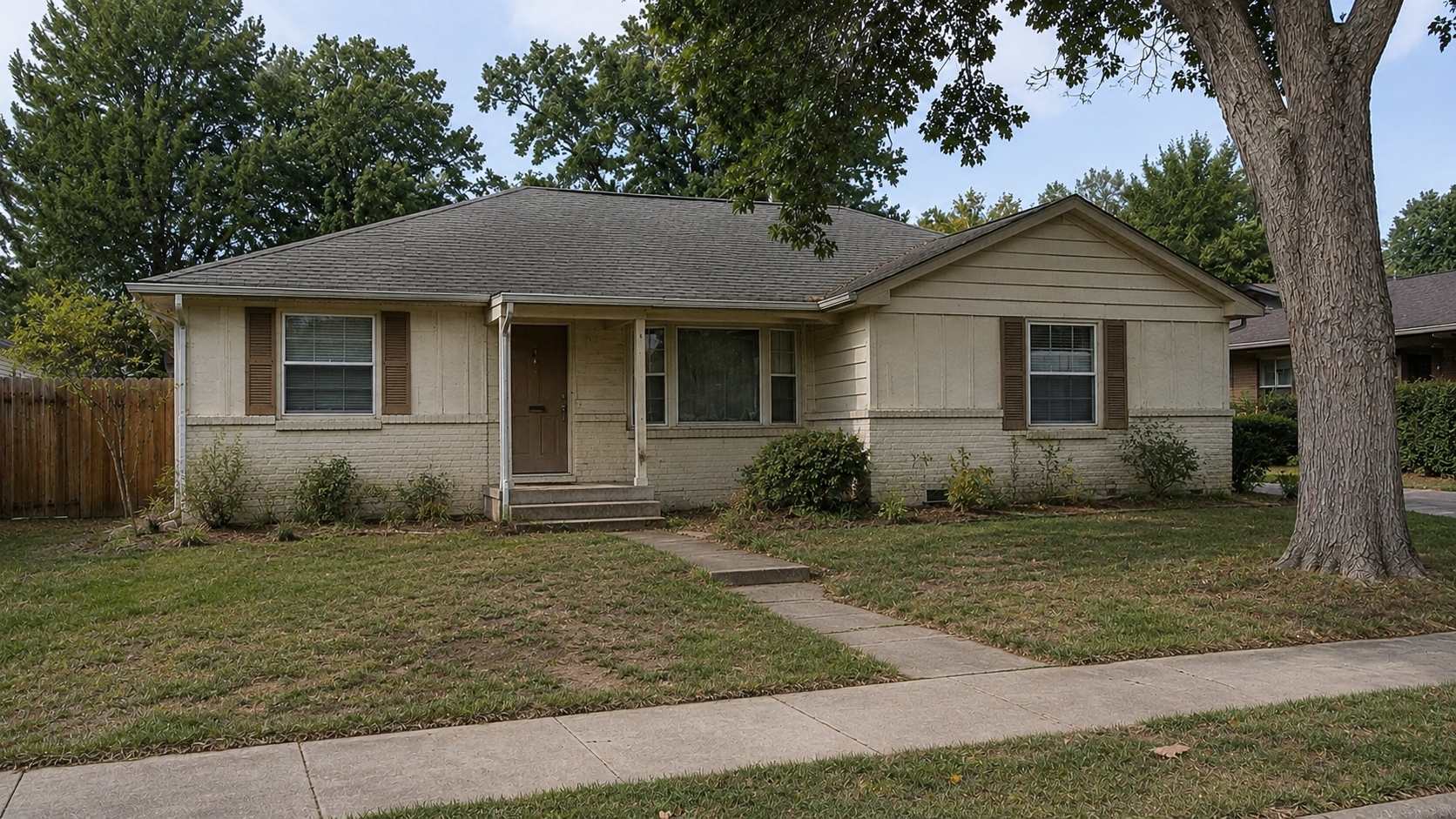 Dated 1980s ranch exterior with worn siding, sparse landscaping, and patchy front lawn.