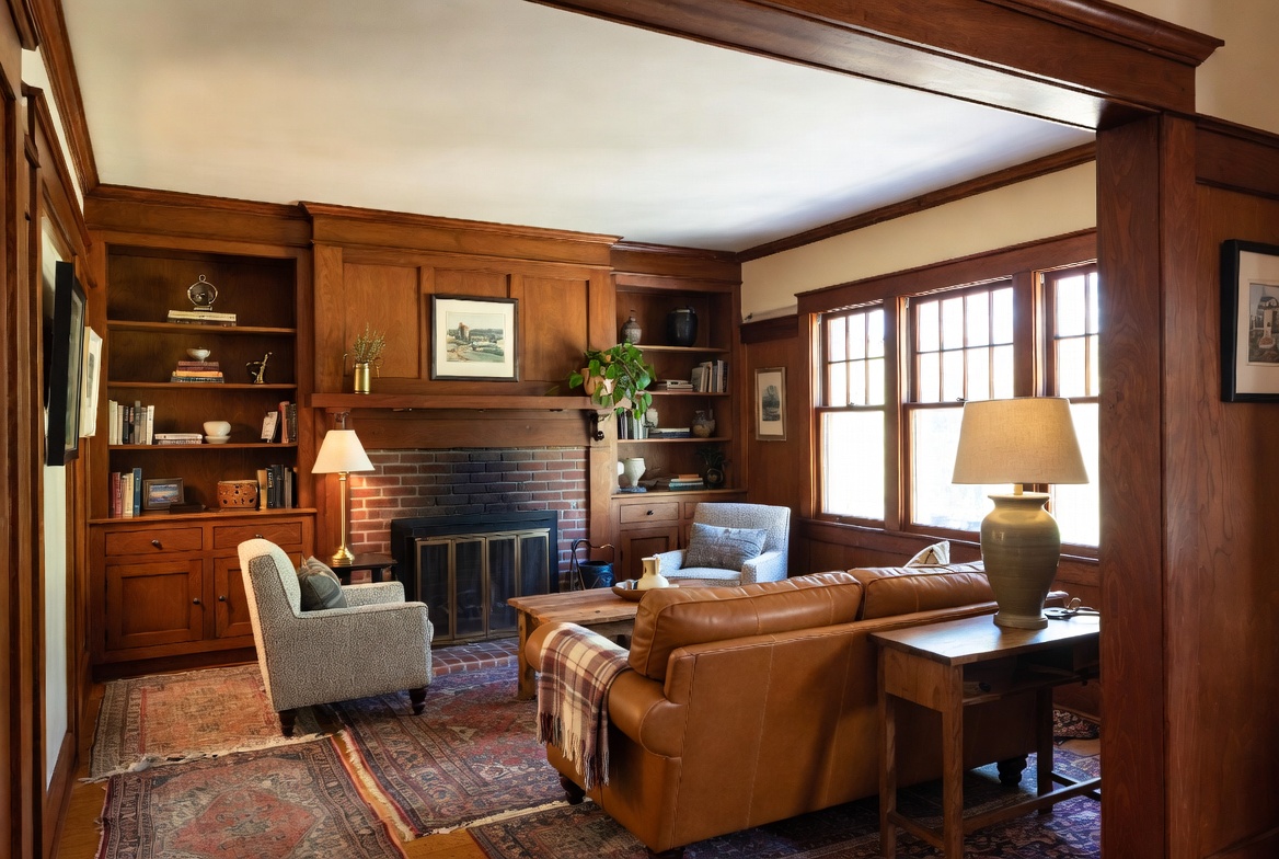 Craftsman living room with fireplace, built-ins, wood trim, and original windows.