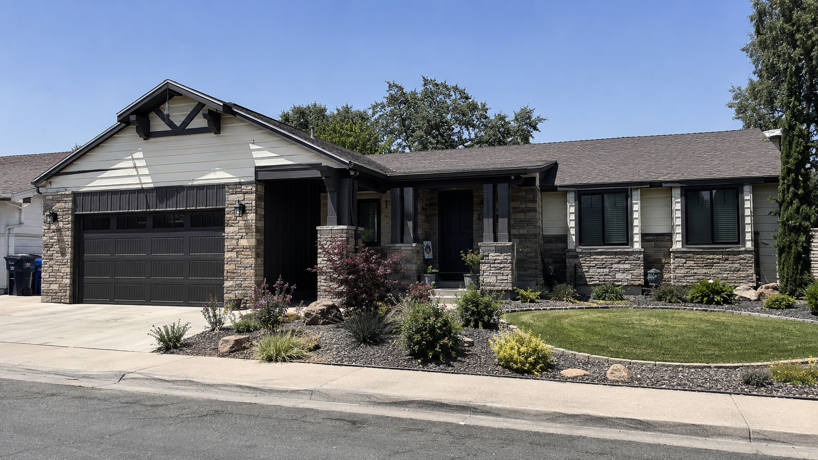 Renovated ranch house with stone cladding, wood porch posts, black windows, and new landscaping.