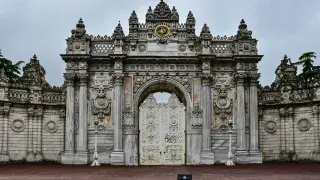 Gate of Dolmabahçe Palace with ornate stonework.