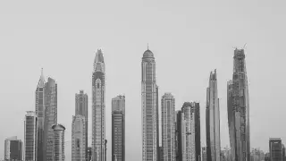 Black and white view of Dubai's iconic skyscrapers towering over the city skyline.